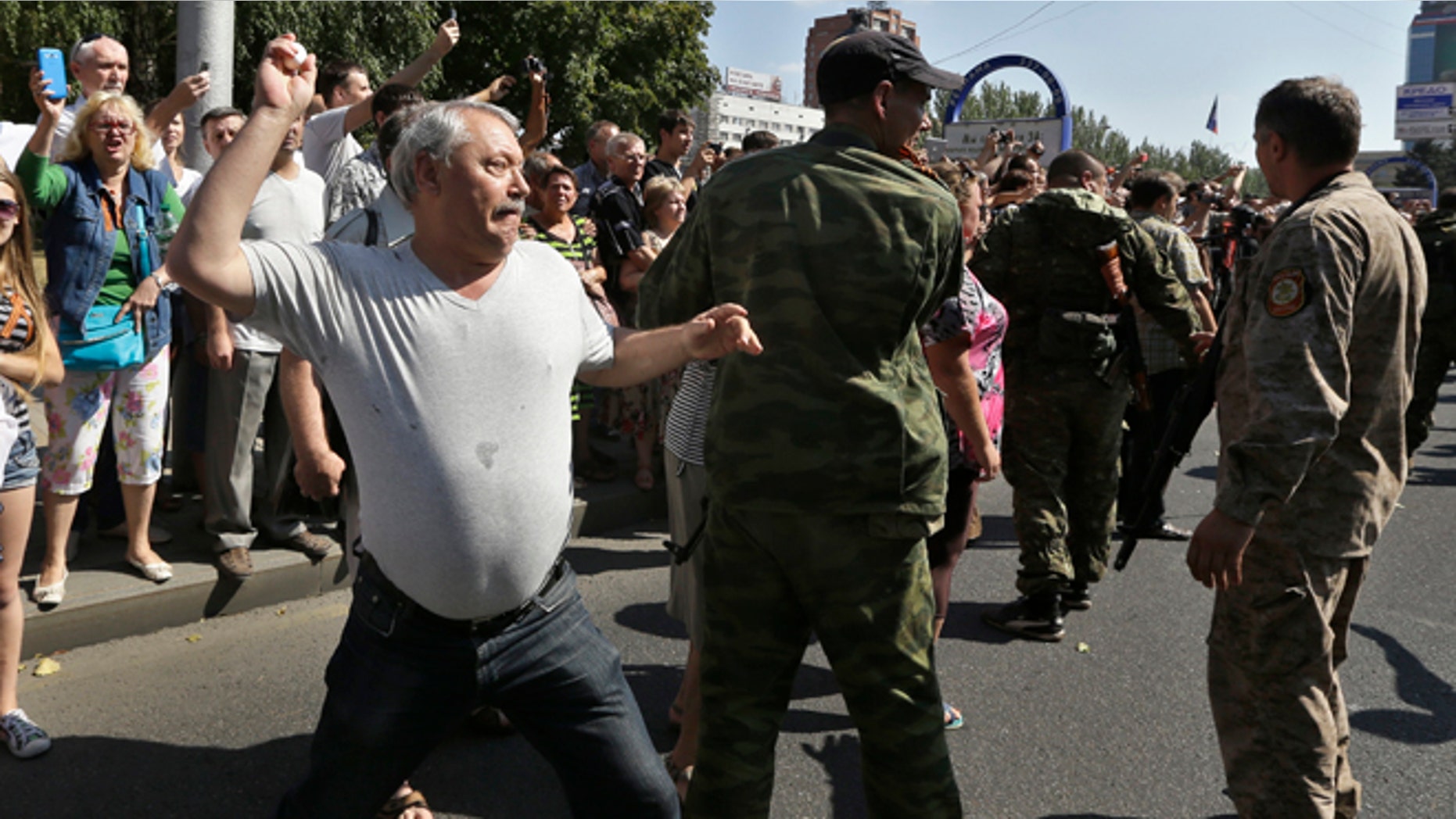 Aug. 24, 2014: A man throws an egg at captured Ukrainian army prisoners as they're escorted by Pro-Russian rebels in a central square in Donetsk, eastern Ukraine. (AP)