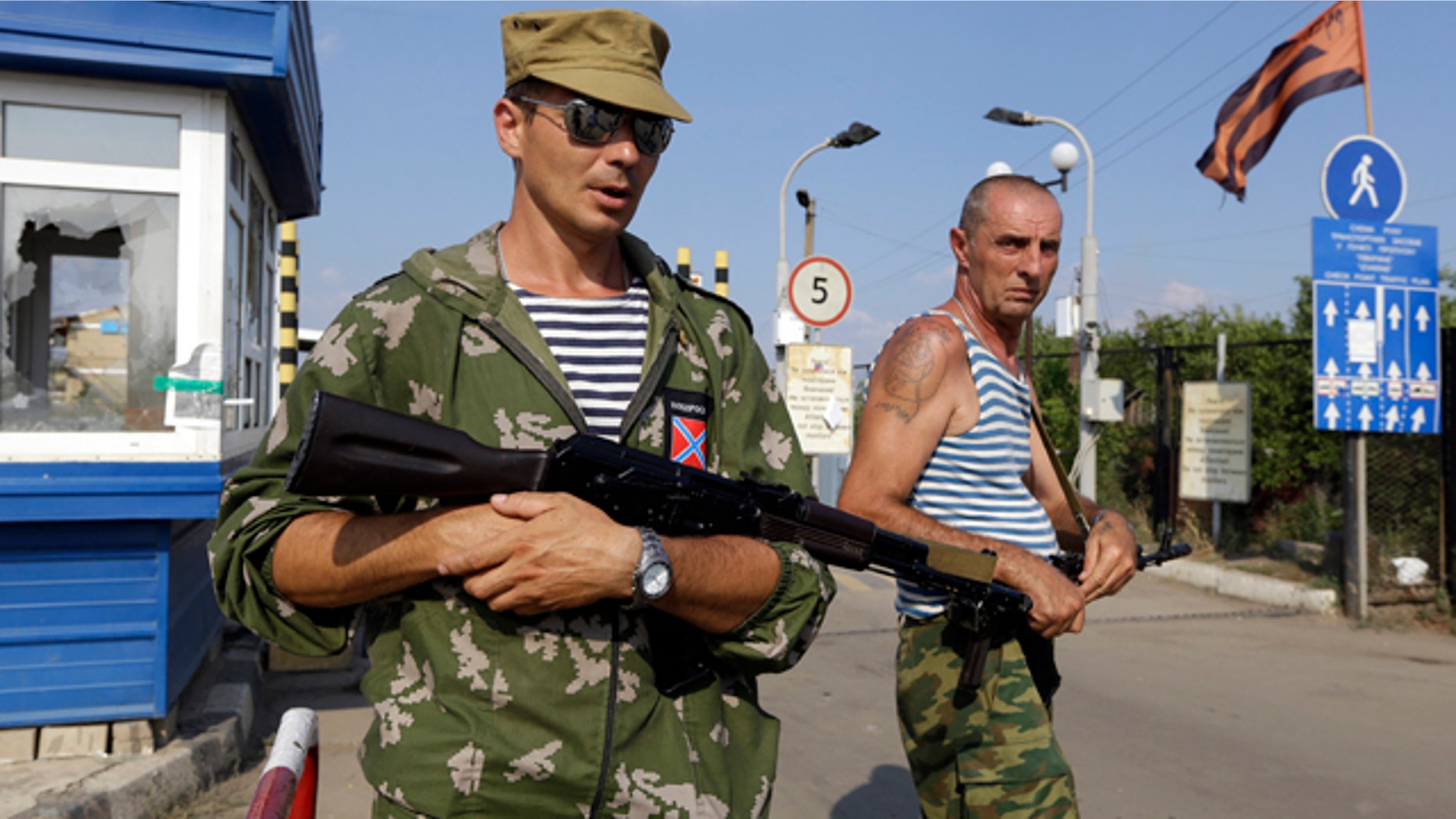 August 16, 2014: Pro-Russian rebels guard a border crossing point 'Izvaryne' on Ukraine-Russia border. (AP Photo/Sergei Grits)
