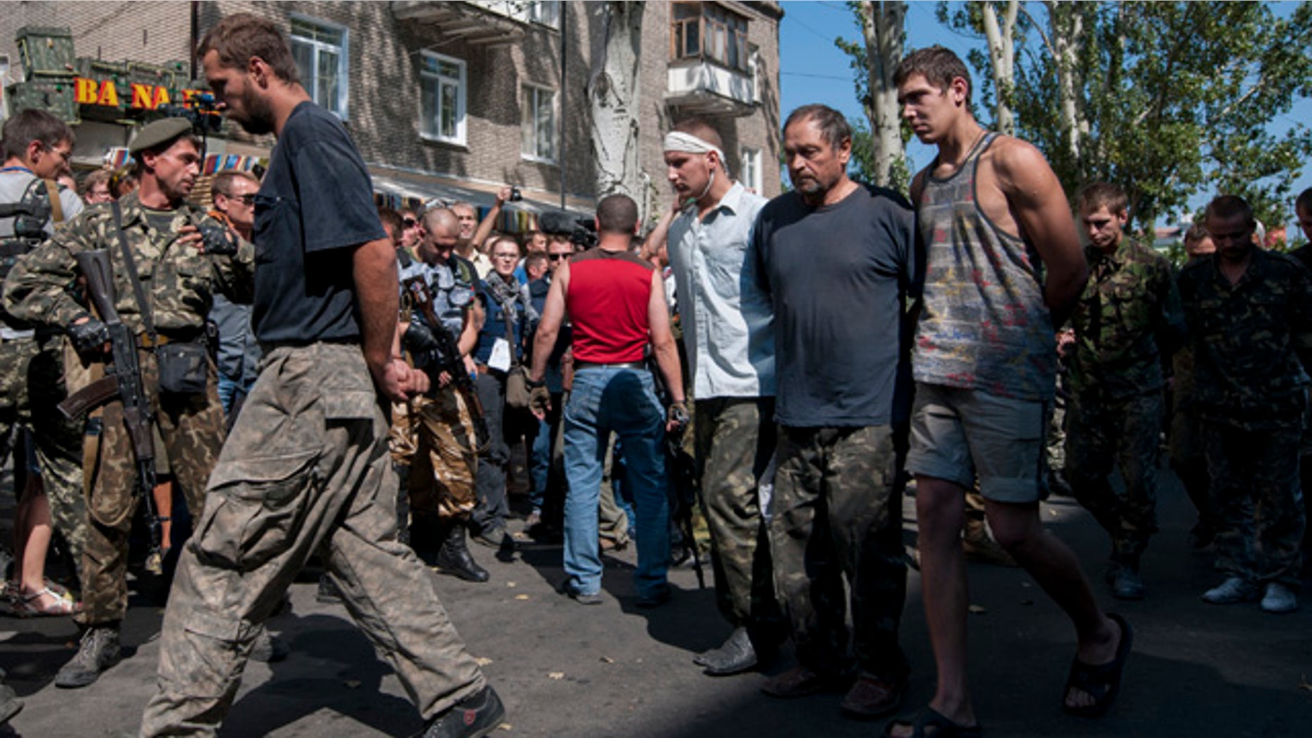 August 24, 2014: Pro-Russian rebels escort captured Ukrainian army prisoners in a central square in Donetsk, eastern Ukraine. (AP Photo/Antoine E.R. Delaunay)