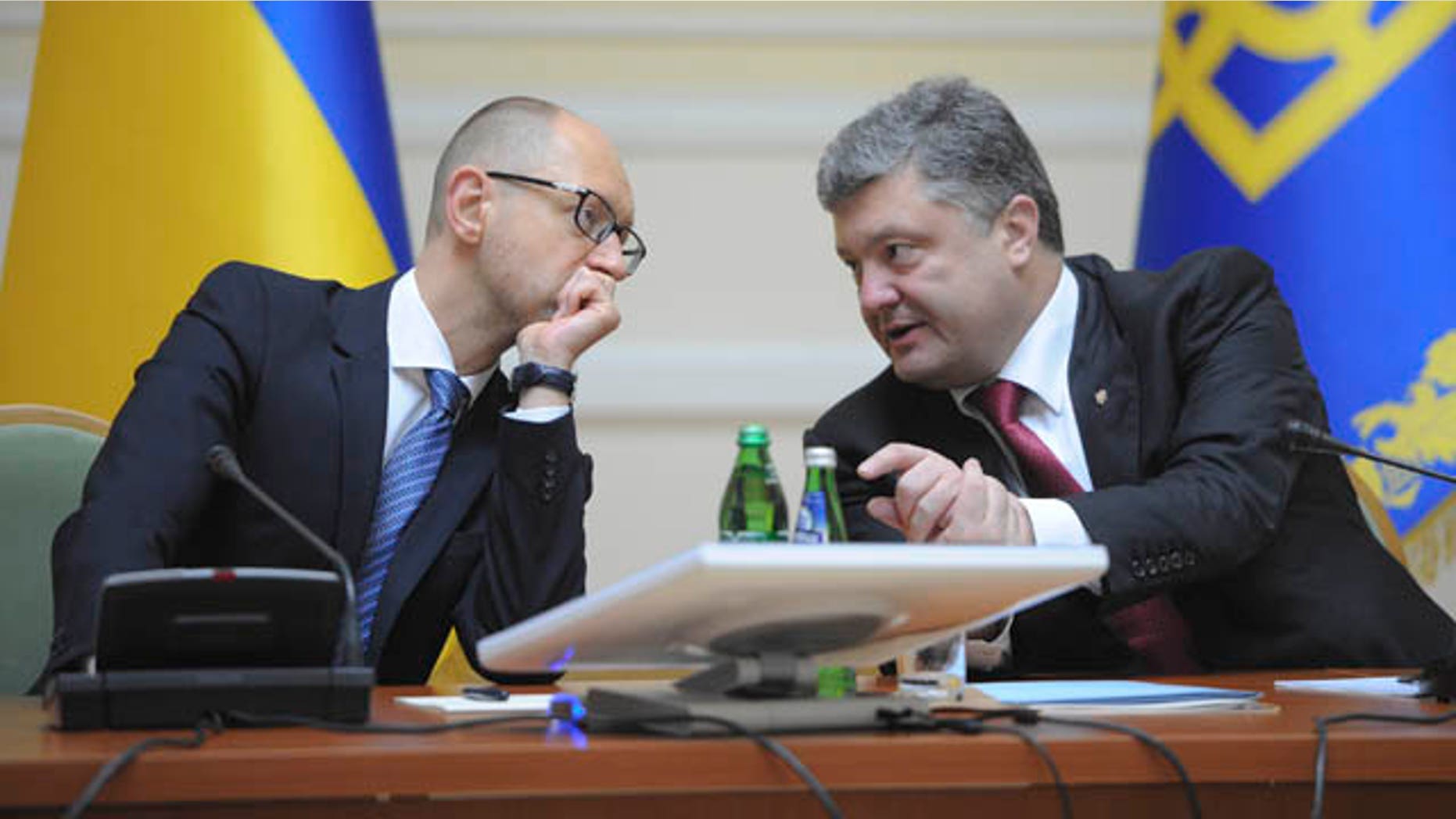 September 10, 2014: Ukrainian President Petro Poroshenko, right, talks with Prime Minister Arseniy Yatsenyuk in Kiev, Ukraine. (AP Photo/Andrew Kravchenko, Pool)