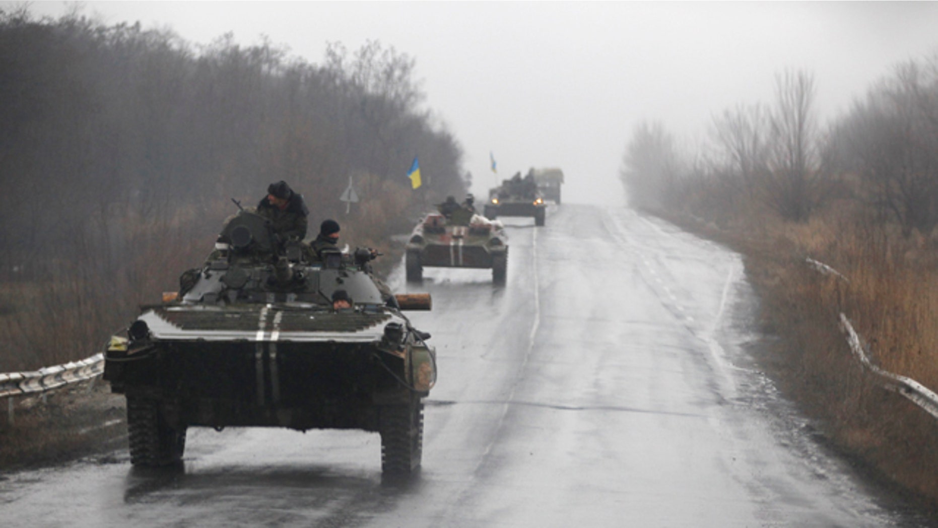 Feb. 1, 2015: Ukranian military vehicles are seen driving on the road towards the town of Artemivsk. Fighting between government and Russian-backed separatist forces in eastern Ukraine has intensified in recent days as rebels seek to encircle the town of Debaltseve, which hosts a strategically important railyway hub. (AP Photo/Petr David Josek)