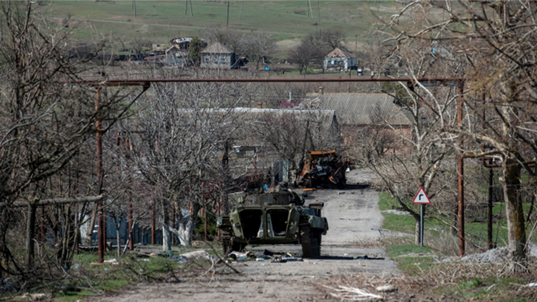 Friday April 10, 2015: A damaged armed vehicle of pro-Russian rebels stands between the positions of pro-Russian rebels and the Ukrainian army in Shyrokyne village, eastern Ukraine. (AP Photo/Evgeniy Maloletka)