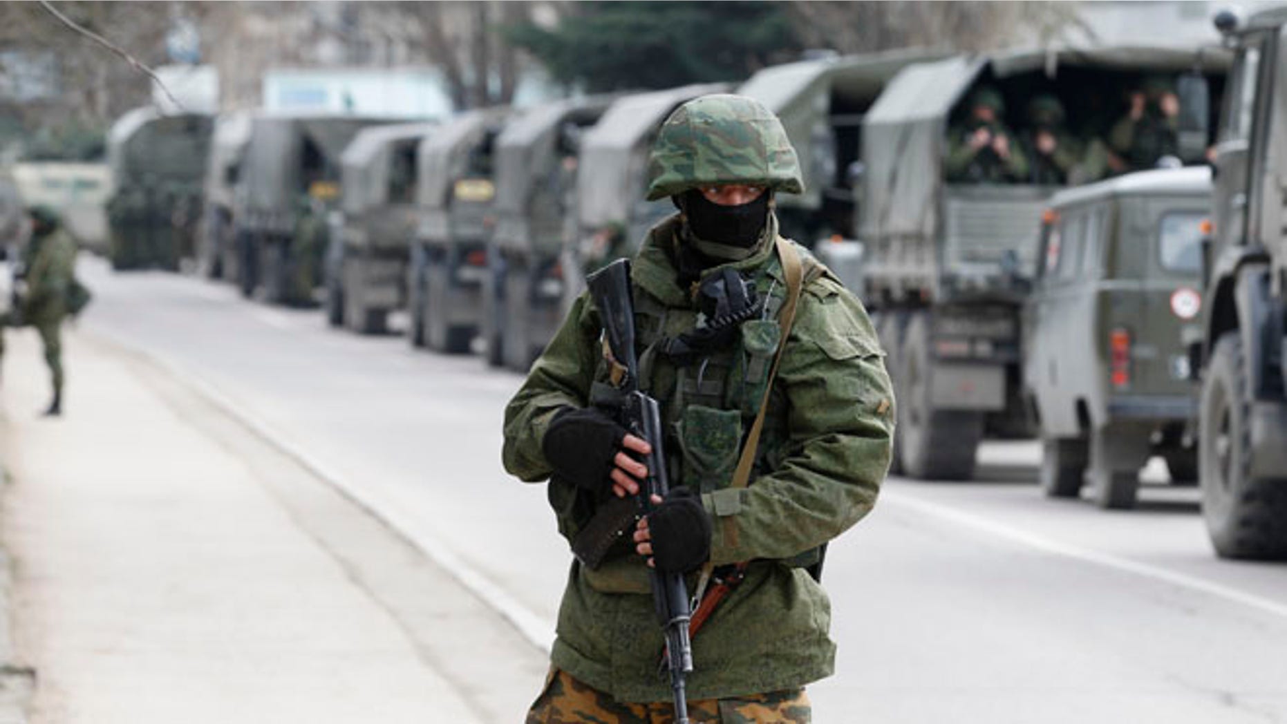 FILE: March 1, 2014: Armed servicemen wait in Russian army vehicles in the Crimean town of Balaclava,Ukraine.
