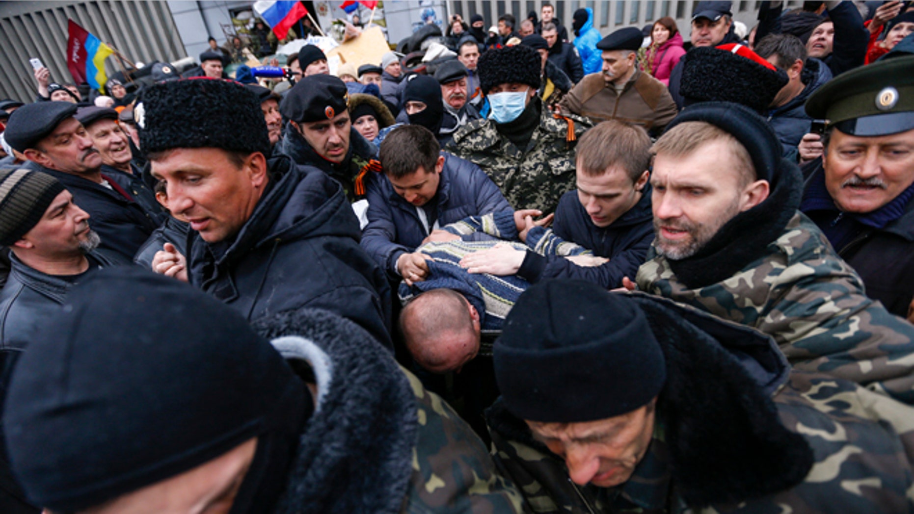 April 13, 2014: Pro-Russian protesters escort a man detained in eastern Ukraine.