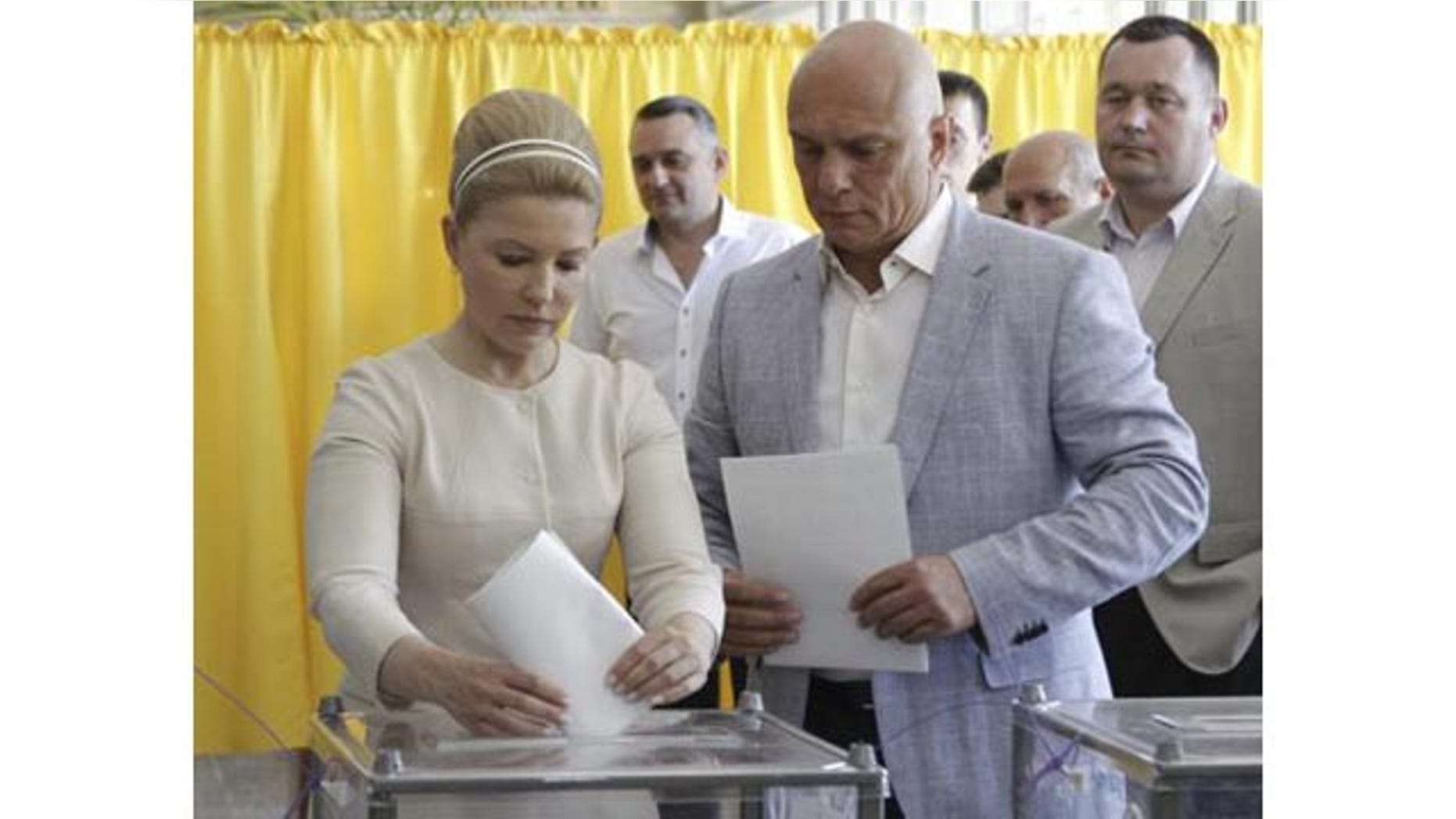 May 25, 2014: Former prime minister and Presidential candidate Yulia Tymoshenko (L), accompanied by her husband Oleksander (R), casts her vote during a presidential election at a polling station in Dnipropetrovsk, Ukraine. (Reuters)