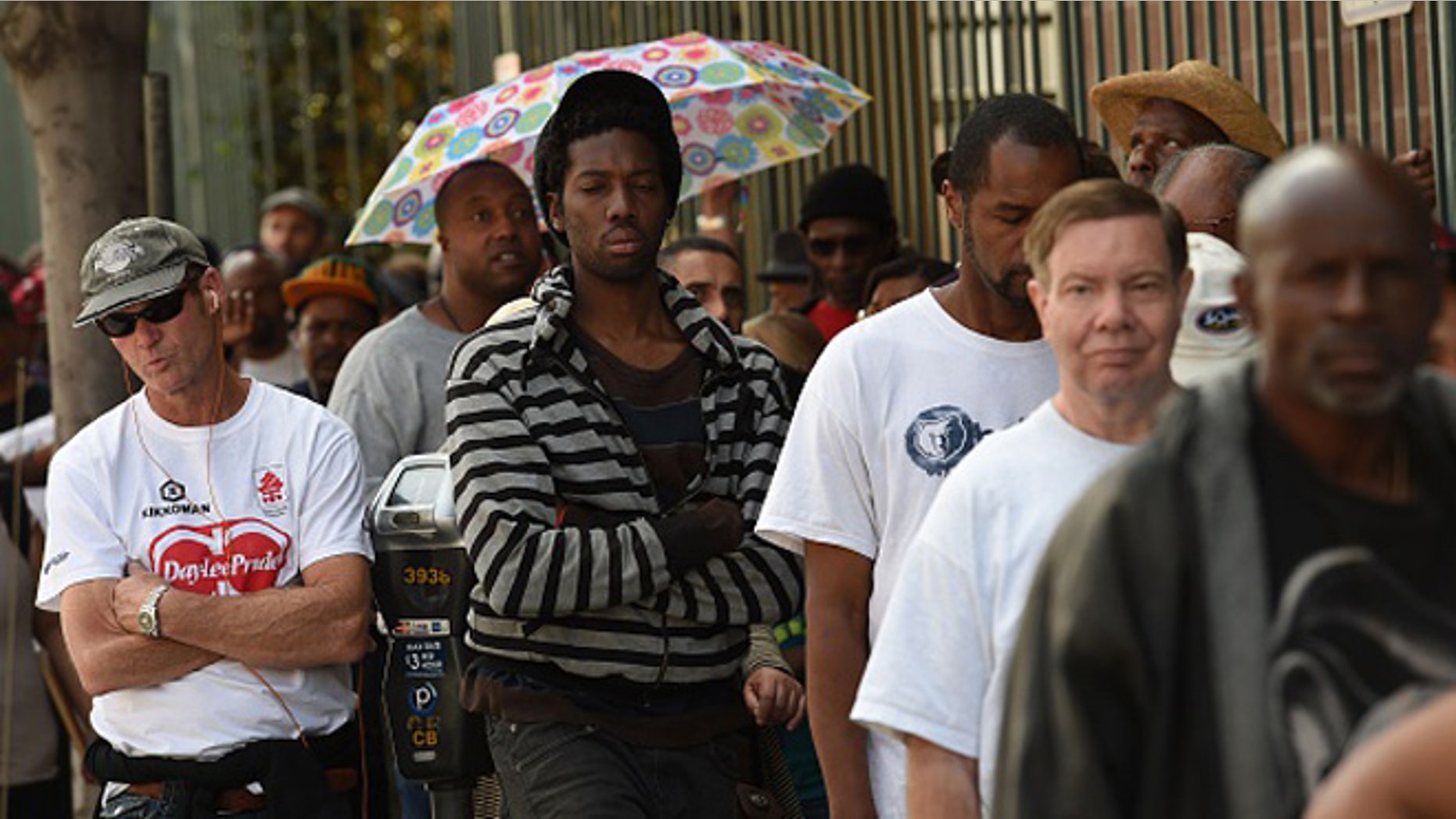Unemployed and homeless people line up for a free meal and new shoes during a Good Friday event in Los Angeles, California on April 3, 2015. After a year of pumping up their payrolls, US employers sharply cut back hiring in March, in a fresh sign of a slowdown in the world's leading economy. AFP PHOTO/ MARK RALSTON (Photo credit should read MARK RALSTON/AFP/Getty Images)