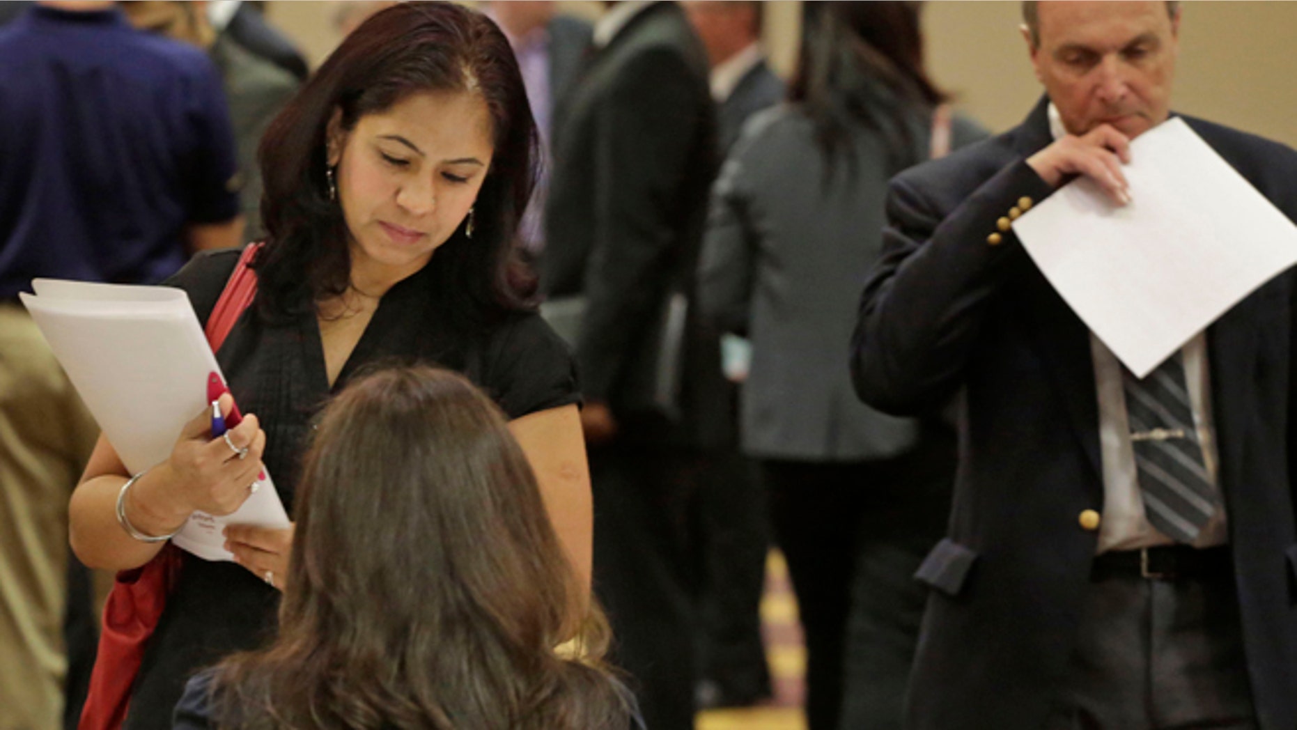 In this May 29, 2013 photo, job seeker Anu Vatal of Chicago, speaks with Patrice Tosi of BluePay, seated, during a career fair in Rolling Meadows, Ill. The U.S. economy added 175,000 jobs in May, a gain that shows employers are hiring at a still-modest but steady pace despite government spending cuts and higher taxes, according to the Labor Department, Friday, June 7, 2013. (AP Photo/M. Spencer Green)