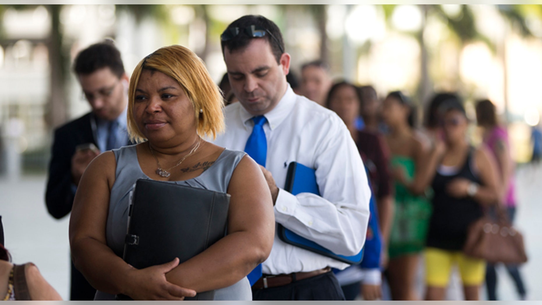 In this Jan. 15, 2013, photo, Racheel Weston, stood in line with a few hundred other job seekers, during a job fair in Miami. (AP Photo/J Pat Carter)