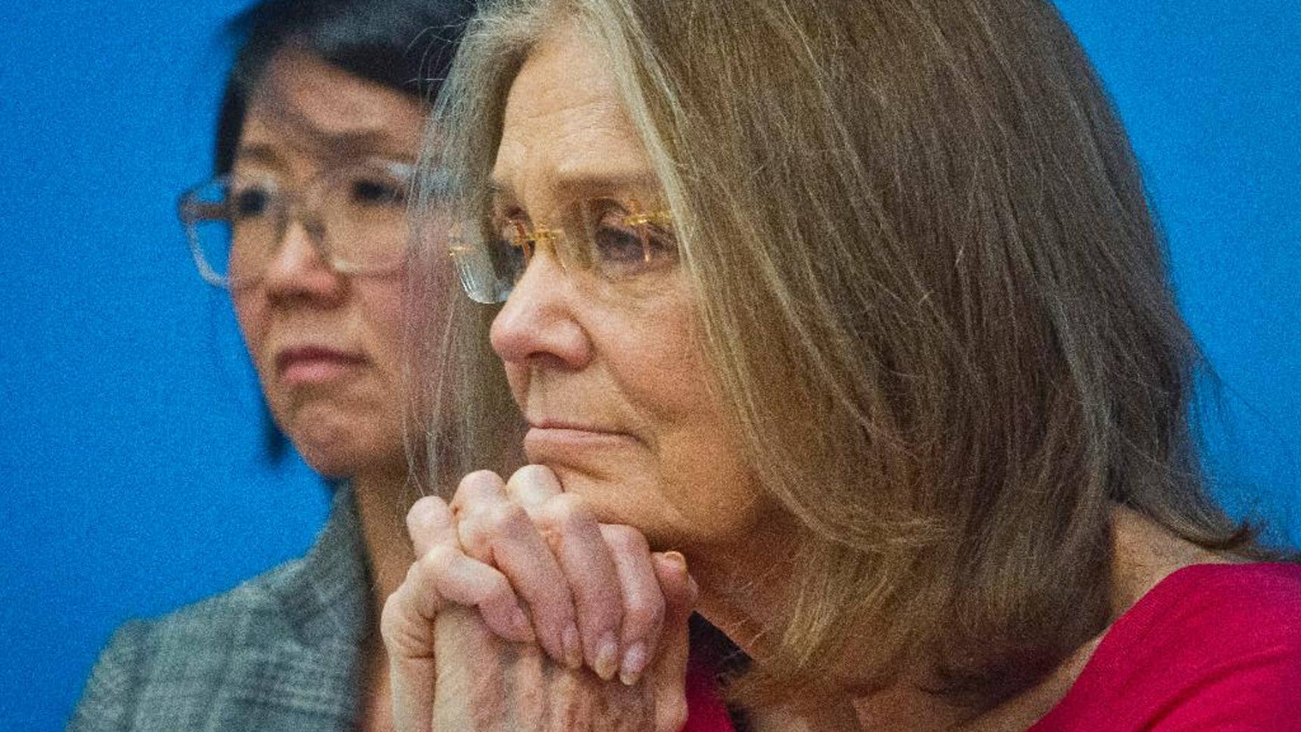 Organizers of the effort called WomenCrossDMZ.org, including honorary co-chair Gloria Steinem, right, and lead coordinator Christine Ahn, left, listen during a United Nations news conference announcing plans for a rare and risky women's walk across the demilitarized zone between North and South Korea to call for reunification, Wednesday, March 11, 2015. (AP Photo/Bebeto Matthews)