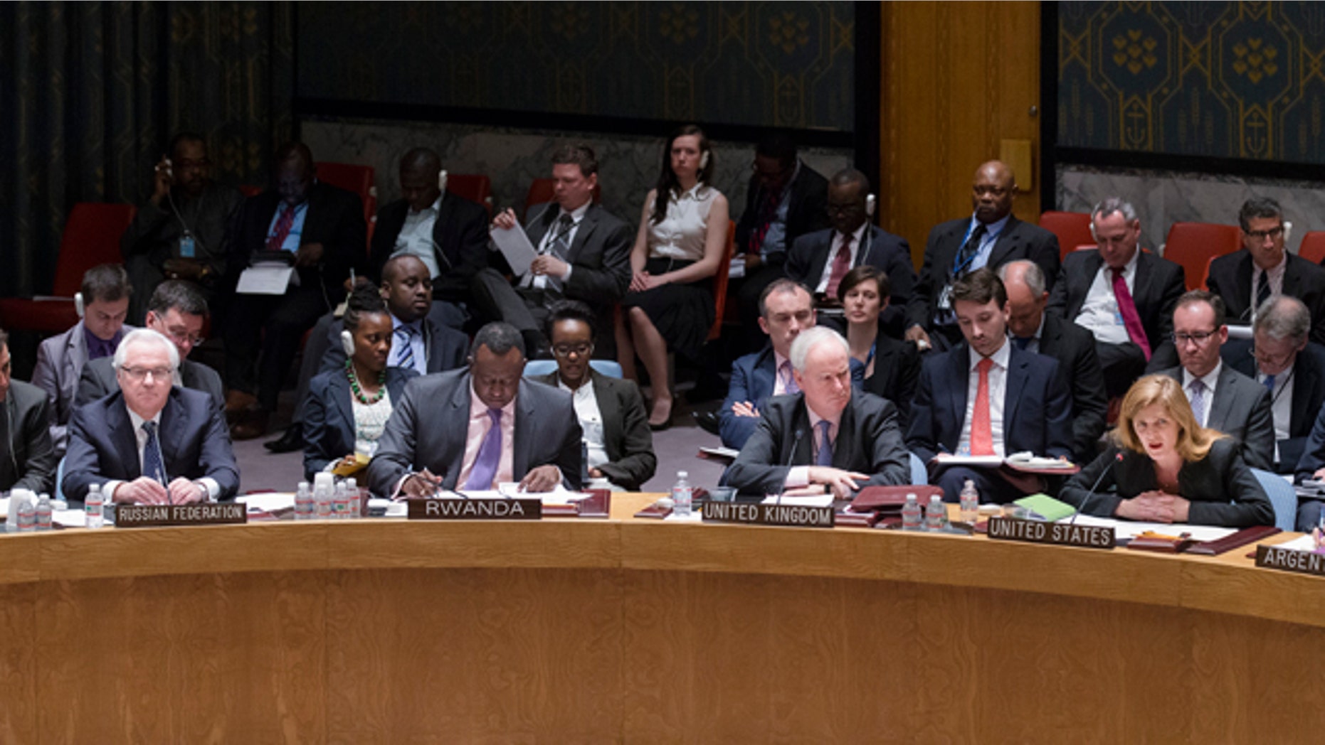 April 13, 2014: Samantha Power, the United States ambassador to the United Nations, right, speaks alongside Mark Lyall Grant, the United Kingdom's ambassador to the United Nations, center right, Eugene Richard Gasana, Rwanda's ambassador to the United Nations, center left, and Vitaly Churkin, the Russian Federation's ambassador to the United Nations, left, during an U.N. Security Council emergency meeting called at Russia's request to discuss the growing crisis in Ukraine. (AP Photo/John Minchillo)