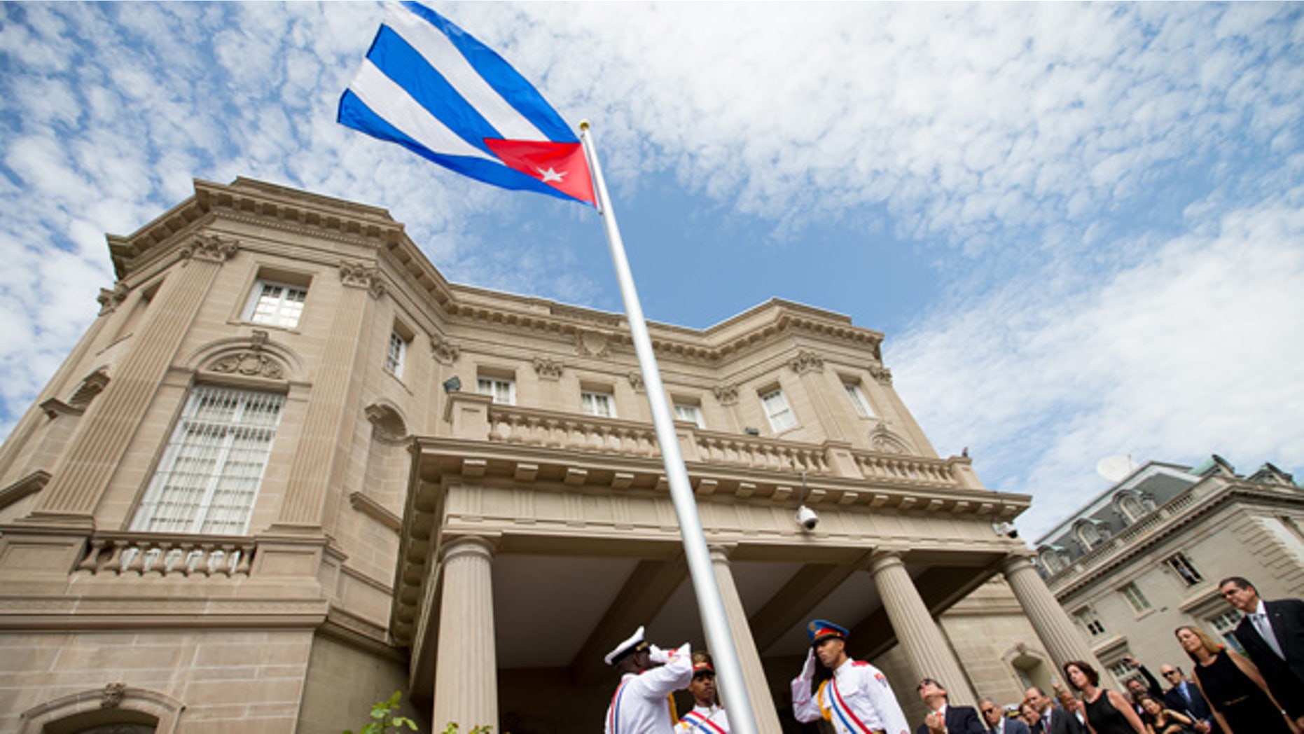 FILE- In this July 20, 2015, file photo, Cuban Foreign Minister Bruno Rodriguez, right of center, applauds with other dignitaries after raising the Cuban flag over their new embassy in Washington. (AP Photo/Andrew Harnik, Pool, File)