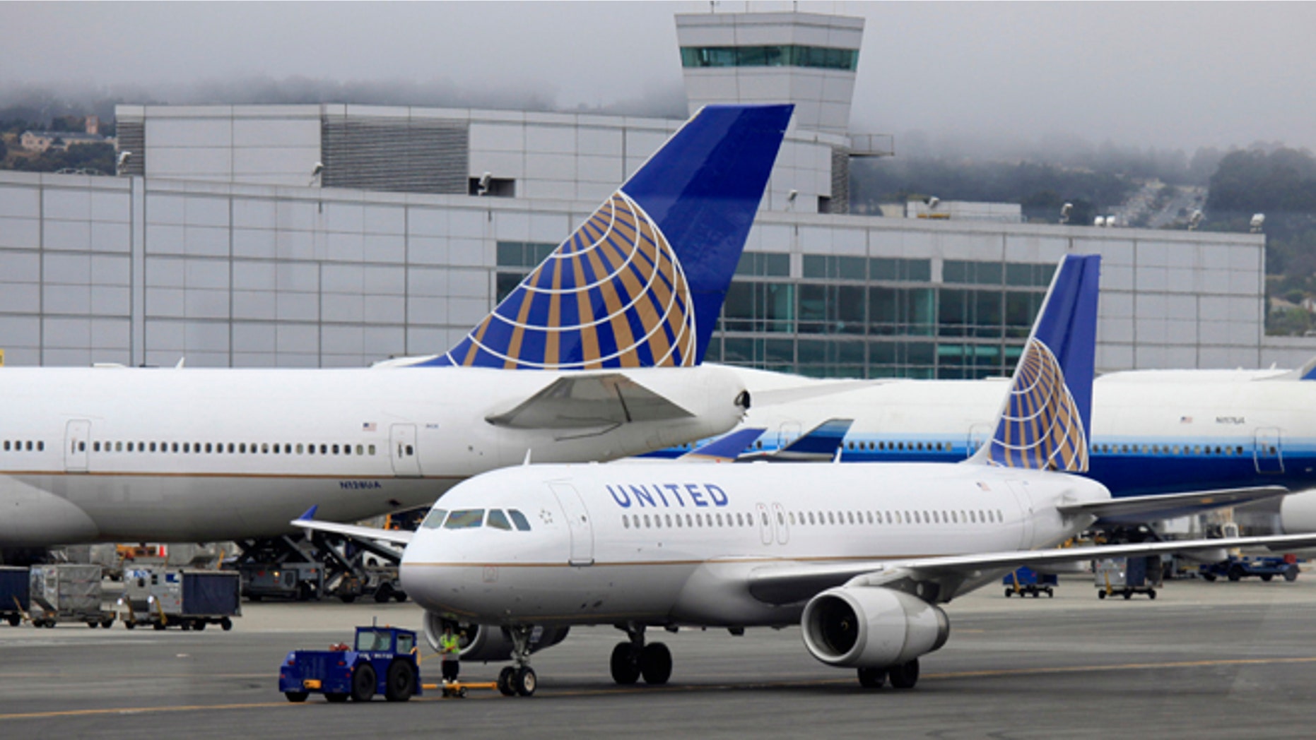 FILE - In this July 13, 2011 file photo, United Airlines planes sit on the tarmac at San Francisco International Airport in San Francisco. Thousands of United Airlines passengers around the globe were delayed for hours Thursday, Nov. 15, 2012 after another massive computer outage hit the worlds largest carrier. This is at least the third major computer outage for the Chicago-based airline since June. (AP Photo/Eric Risberg, File)