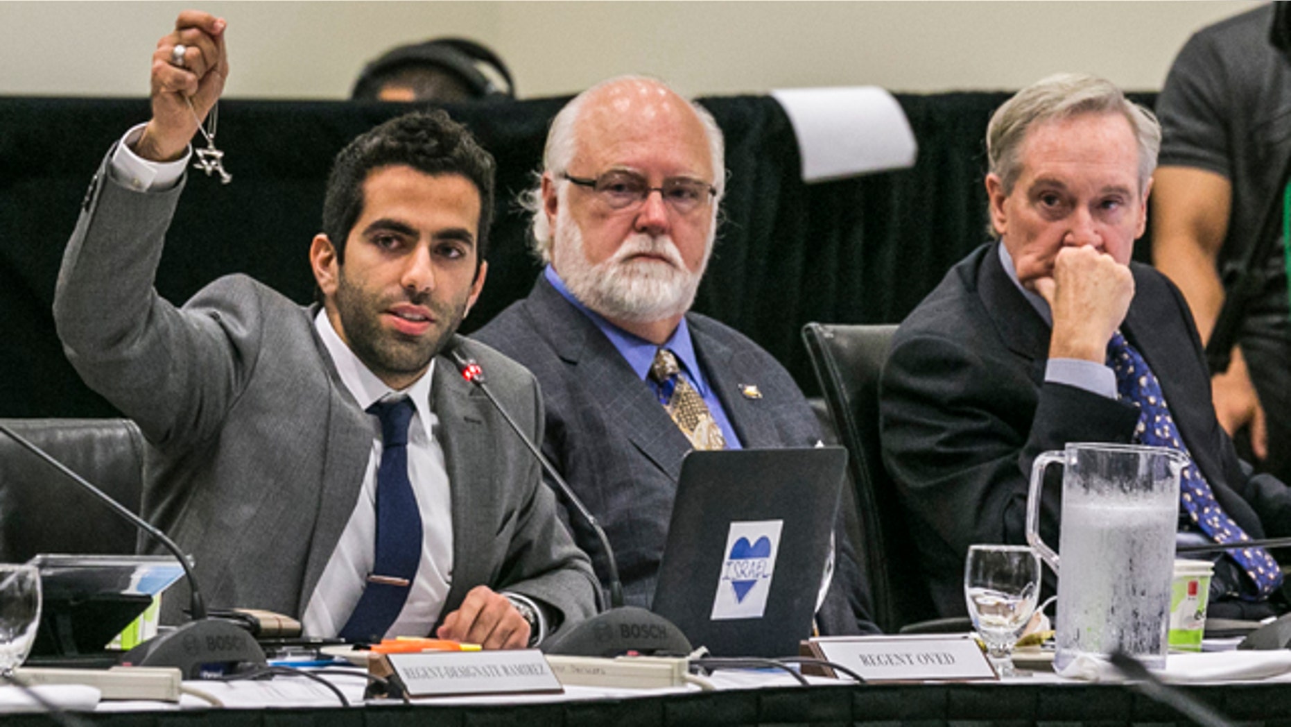Sept. 17, 2015: University of Californias Student Regent, Abraham Oved, left, holds up a Star of David as he addresses the UC Irvine Board of Regents meeting at the UC Irvine Student Center to discuss a controversial policy statement on intolerance at the campus in Irvine, Calif. (AP Photo/Damian Dovarganes)