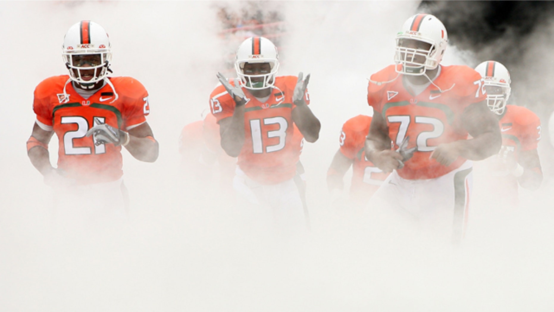 CORAL GABLES, FL - OCTOBER 13: Derron Thomas #21, Ryan Hill #13 and Andrew Bain of the Miami Hurricanes run out of the tunnel prior to taking on the Georgia Tech Yellow Jackets at the Orange Bowl on October 13, 2007 in Coral Gables, Florida. (Photo by Doug Benc/Getty Images) *** Local Caption *** Derron Thomas;Ryan Hill;Andrew Bain