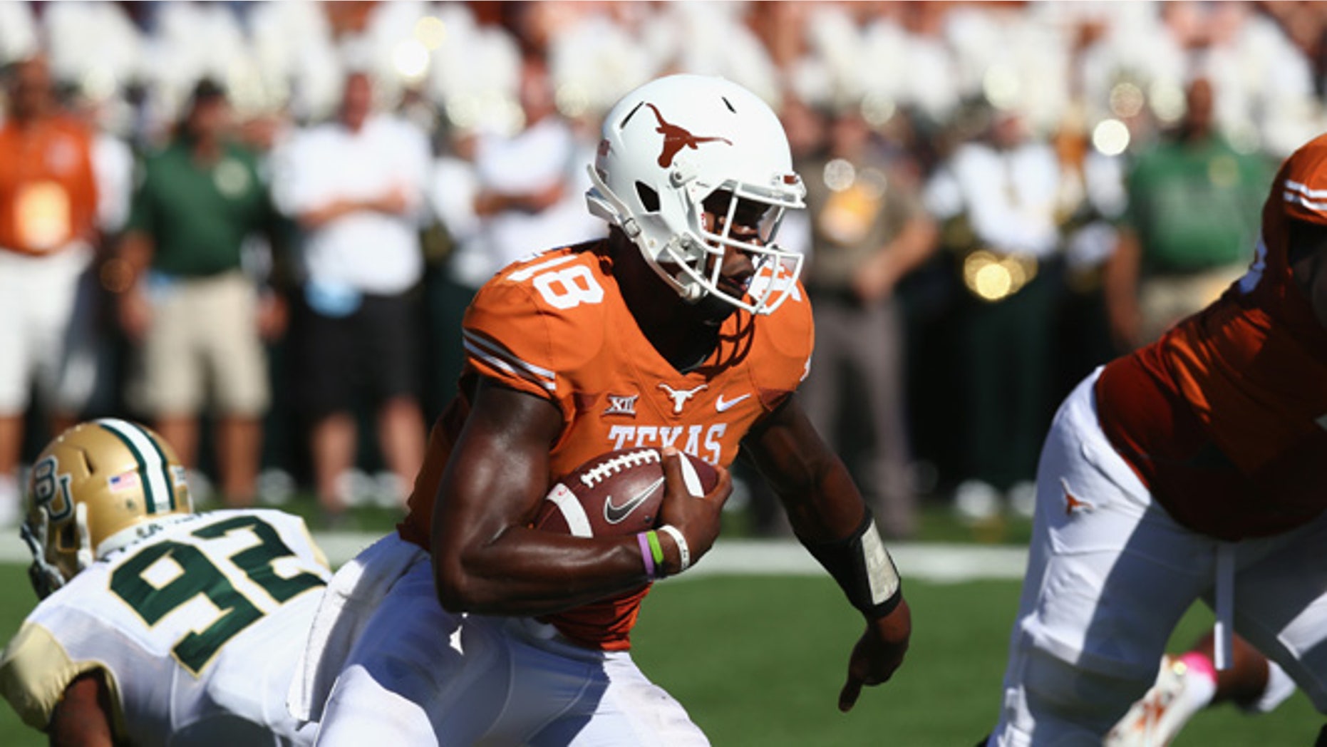 AUSTIN, TX - OCTOBER 04: Tyrone Swoopes #18 of the Texas Longhorns runs the ball against the Baylor Bears at Darrell K Royal-Texas Memorial Stadium on October 4, 2014 in Austin, Texas. (Photo by Ronald Martinez/Getty Images)