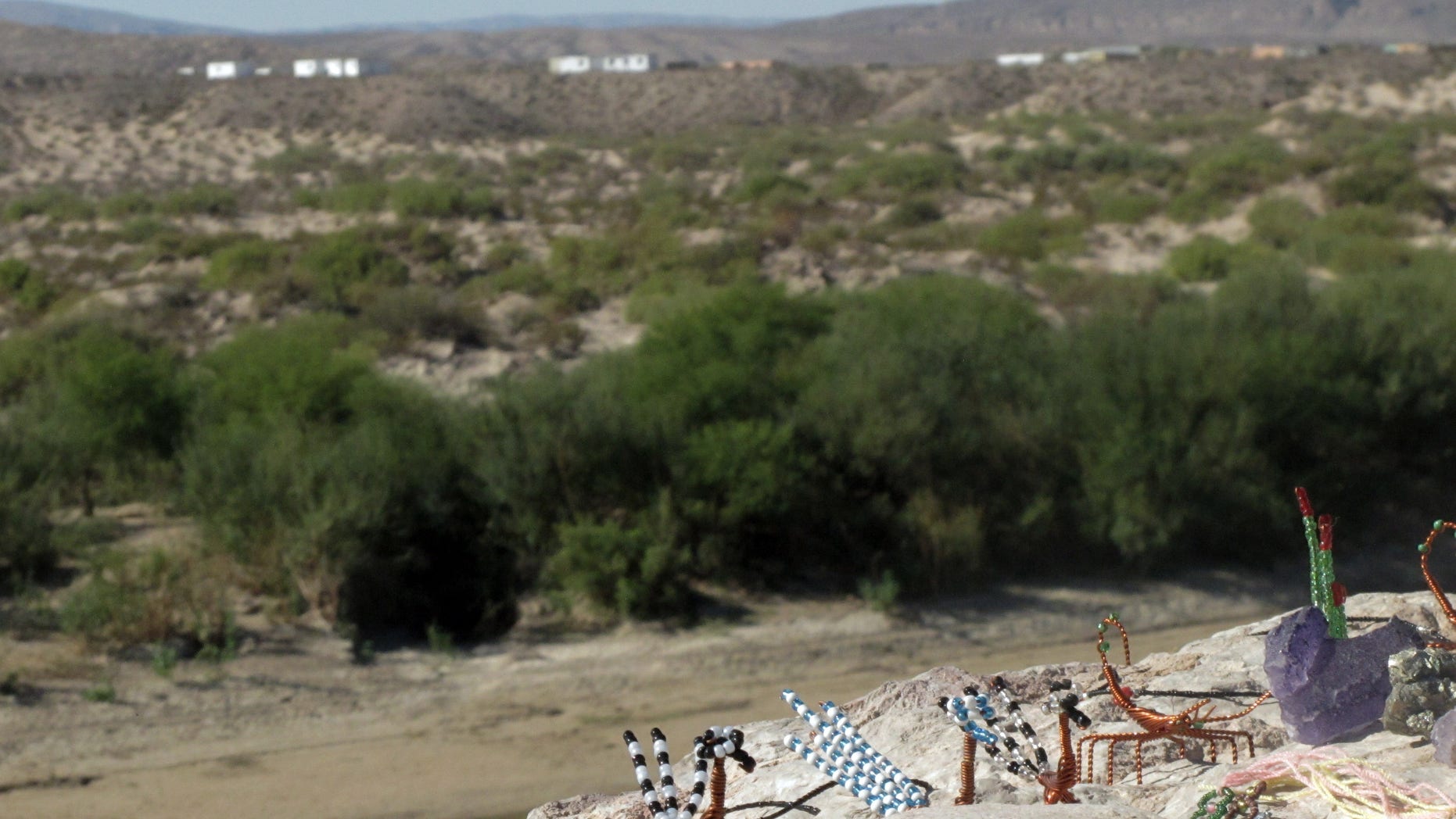 In this Oct. 31, 2011 photo, handicrafts made in Boquillas del Carmen, Mexico across the Rio Grande await tourists at an overlook in Big Bend National Park, Texas. In this rugged, remote West Texas terrain where wading across the shallow Rio Grande undetected is all too easy, federal authorities are touting a proposal to open an unmanned port of entry as a security upgrade. If approved, the crossing would be the nation's first such port of entry with Mexico. (AP Photo/Christopher Sherman)