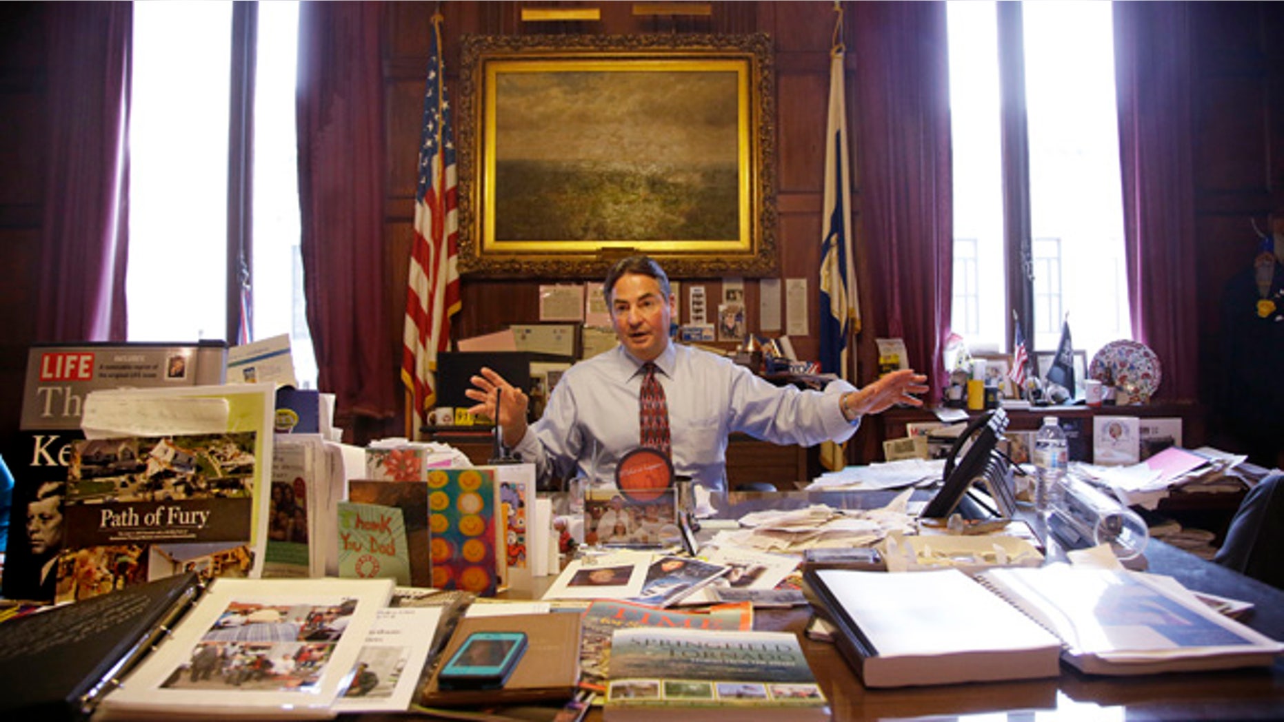June 5, 2014: Springfield Mayor Domenic Sarno sits behind his city hall desk reiterating the position he has taken with the United States State Department against accepting any more resettled refugees in Springfield, Mass. (AP Photo/Stephan Savoia)