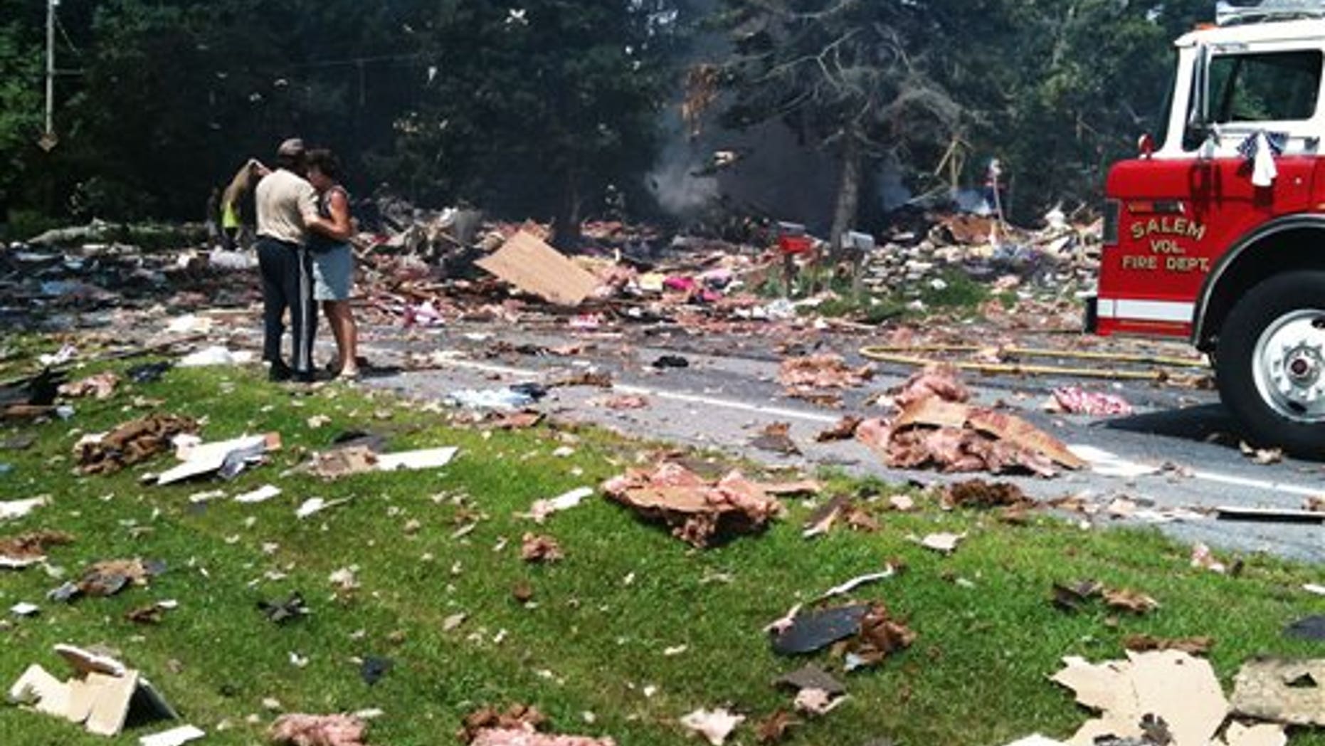 July 13: Landlords David and Linda Baldwin embrace amid the debris of their rental home after it exploded on Route 29 1/2 mile west of the intersection with Route 22 in Salem, N.Y.