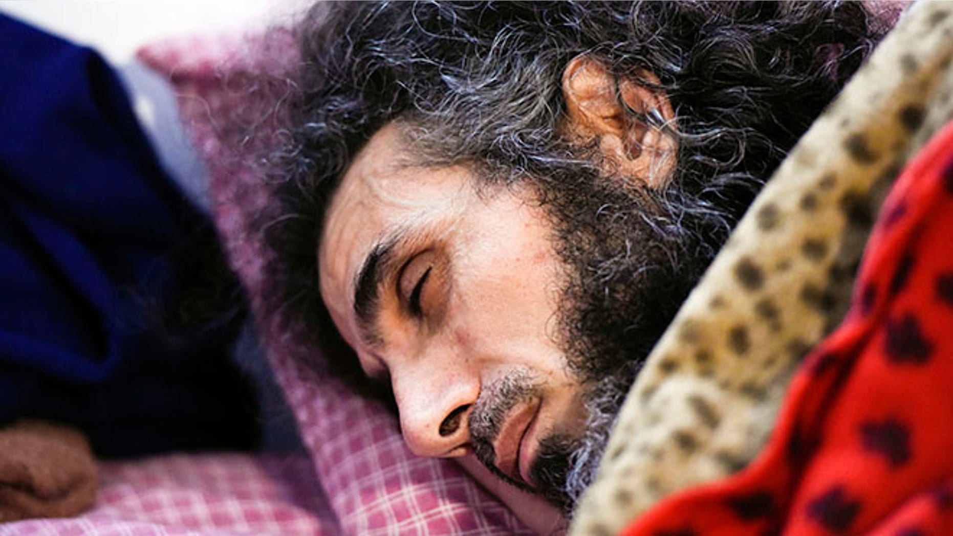 FILE - In this Sept. 9, 2016 file photo, Syrian native Abu Wa'el Dhiab rests in bed while conversing with his family via a laptop, in his apartment in Montevideo, Uruguay. An Uruguayan official said on Sept. 14 that the health of the resettled former Guantanamo detainee has taken a turn for the worse due to a hunger strike he launched to demand relocation to another country. He says he no longer wants to remain in Uruguay and would like to join his wife and daughters in Turkey. Uruguayan officials say they are trying to find another country to accept him. (AP Photo/Matilde Campodonico, File)