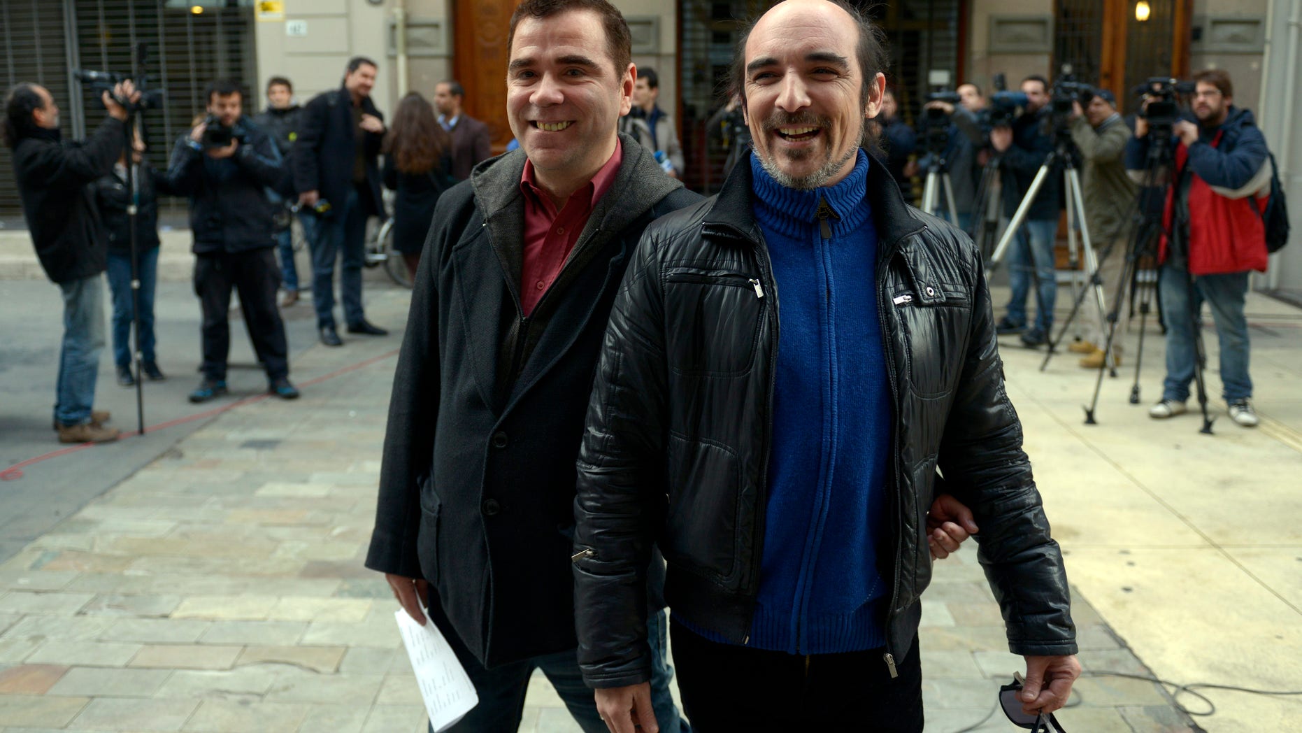 Rodrigo Borda and his partner Sergio Miranda leave the Civil Registry office where they signed up to marry in Montevideo, Uruguay, Monday, Aug. 5, 2013.