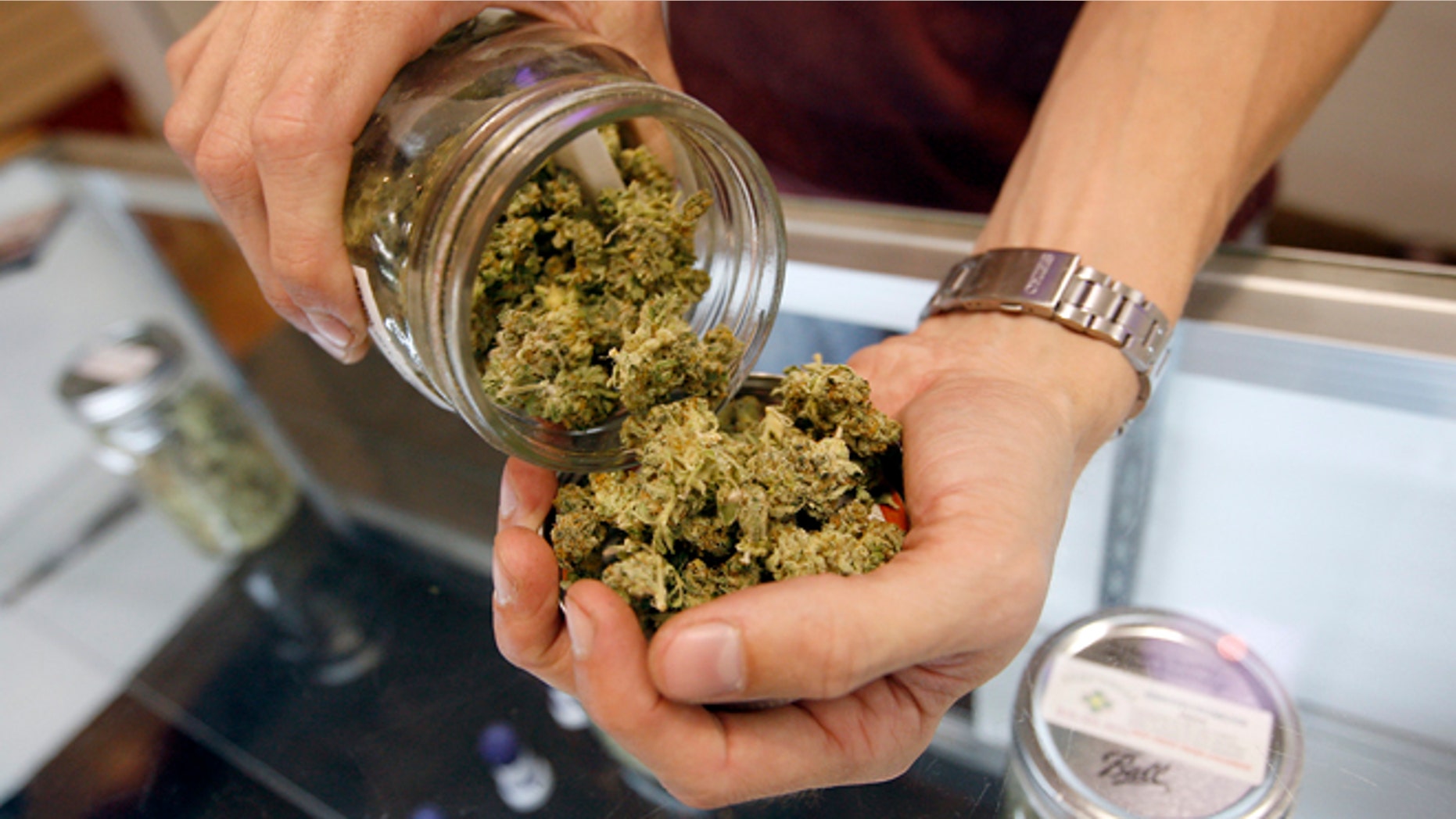 LOS ANGELES, CA - JULY 25: A budtender pours marijuana from a jar at Perennial Holistic Wellness Center medical marijuana dispensary, which opened in 2006, on July 25, 2012 in Los Angeles, California. The Los Angeles City Council has unanimously voted to ban storefront medical marijuana dispensaries and to order them to close or face legal action. The council also voted to instruct staff to draw up a separate ordinance for consideration in about three months that might allow dispensaries that existed before a 2007 moratorium on new dispensaries to continue to operate. It is estimated that Los Angeles has about one thousand such facilities. The ban does not prevent patients or cooperatives of two or three people to grow their own in small amounts. Californians voted to legalize medical cannabis use in 1996, clashing with federal drug laws. The state Supreme Court is expected to consider ruling on whether cities can regulate and ban dispensaries. (Photo by David McNew/Getty Images)