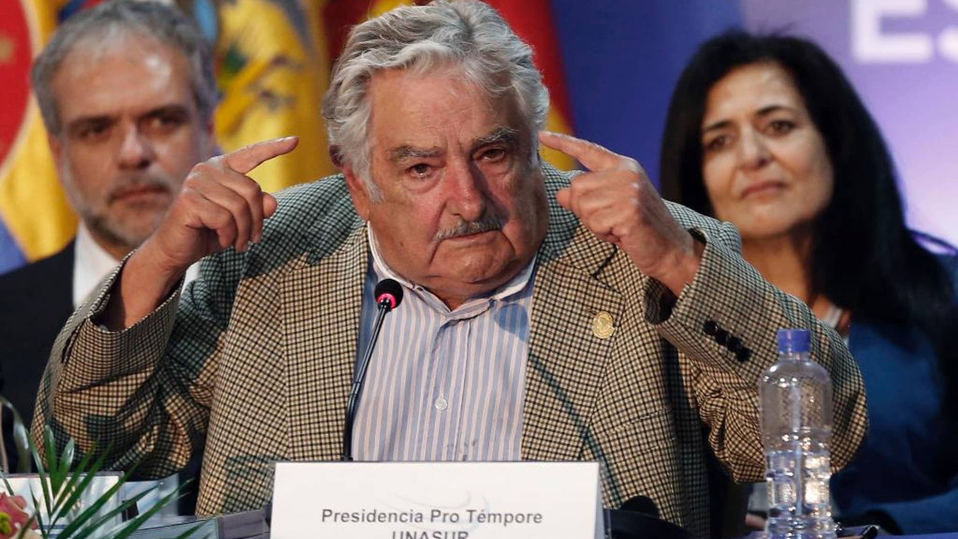 ALTERNATIVE CROP OF DOR115 - New UNASUR President Jose Mujica, President of Uruguay, left, speaks during the UNASUR summit in Guayaquil, Ecuador, Thursday, Dec. 4, 2014. Mujica is reiterating his willingness to resettle six Guantanamo prisoners in his country while calling on the United States to end its decades-old embargo against Cuba. Mujica's open letter to President Barack Obama appeared Friday on his presidency website. (AP Photo/Dolores Ochoa)