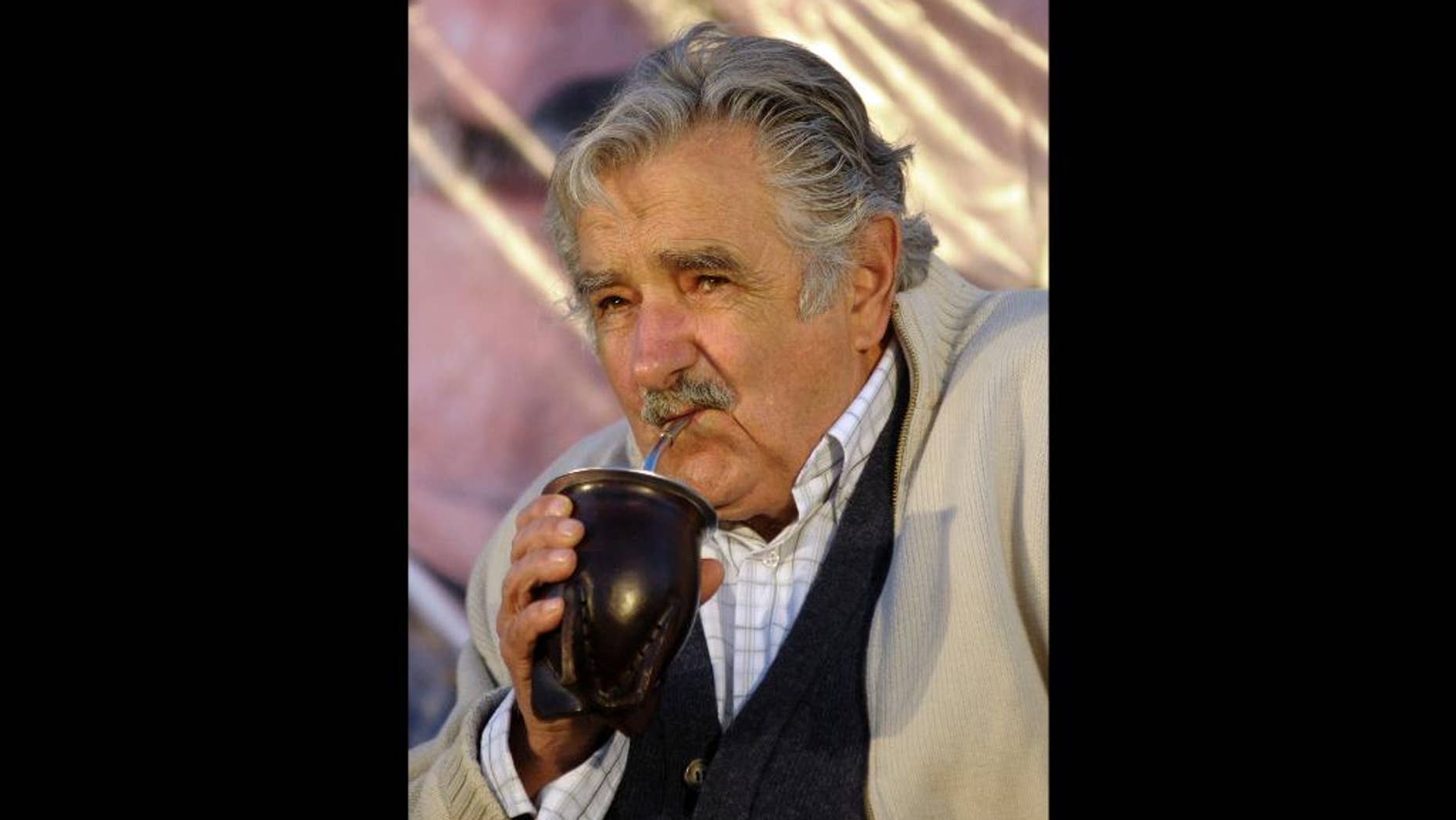 FILE - In this Oct. 22, 2009 file photo, Jose Mujica, presidential candidate for the ruling party Frente Amplio, drinks mate during a closing campaign election rally, in Pando, Uruguay. Paraguayan yerba mate producers say Mujica is thirsty for more of the traditional tea for his country and is asking them to fill the need at a lower price. (AP Photo/Matilde Campodonico, File)