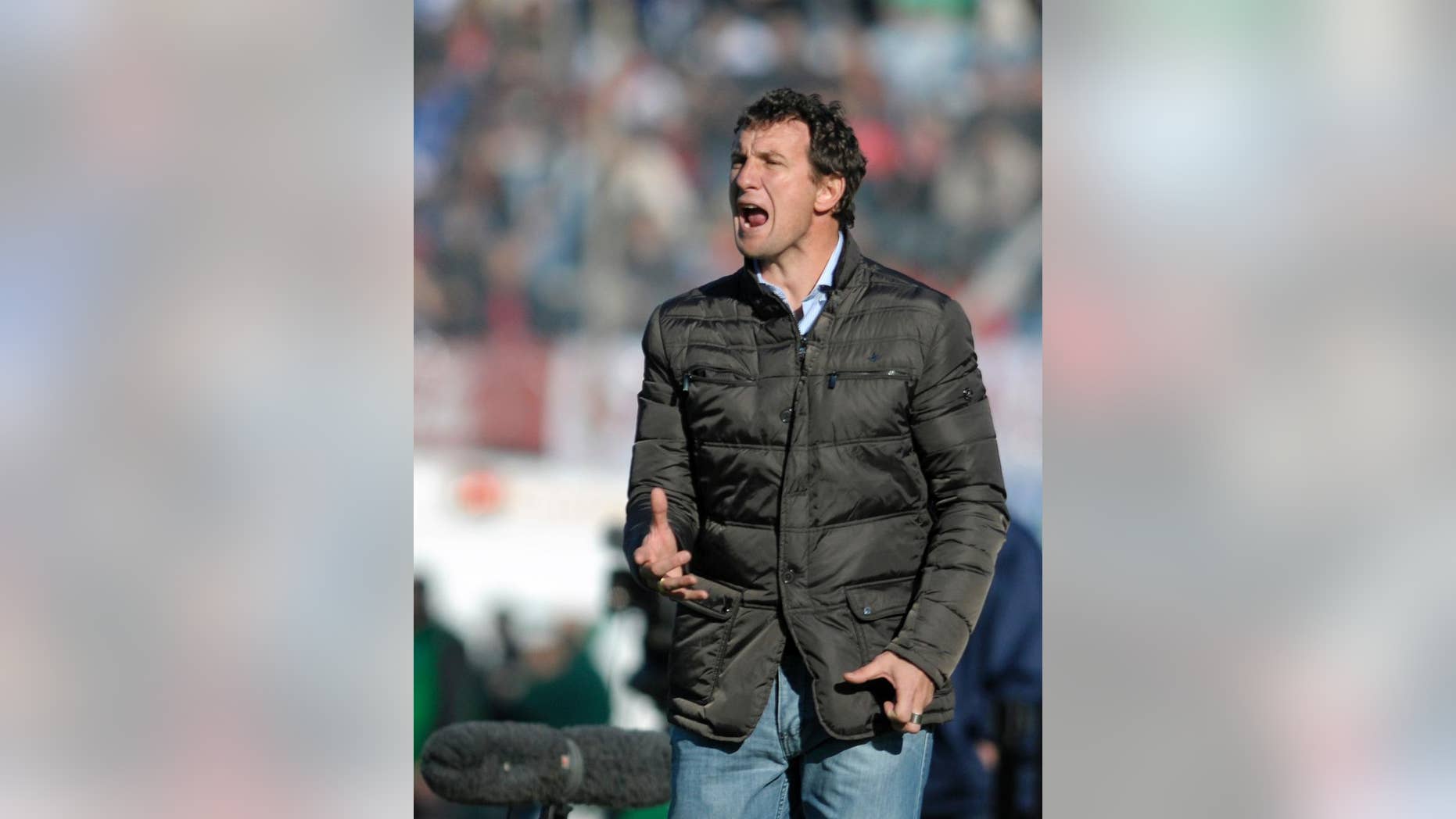 FILE - In this Aug. 4, 2013 file photo, coach of Uruguay's Nacional soccer team, Rodolfo Arruabarrena, yells from the sidelines of a friendly soccer game against Spain's Atletico de Madrid in Montevideo, Uruguay. Arruabarrena became the new coach for Argentina's Boca Juniors, replacing fired coach Carlos Bianchi, announced Friday, Aug. 29, 2014 by the club on their official website. (AP Photo/Matilde Campodonico, File)