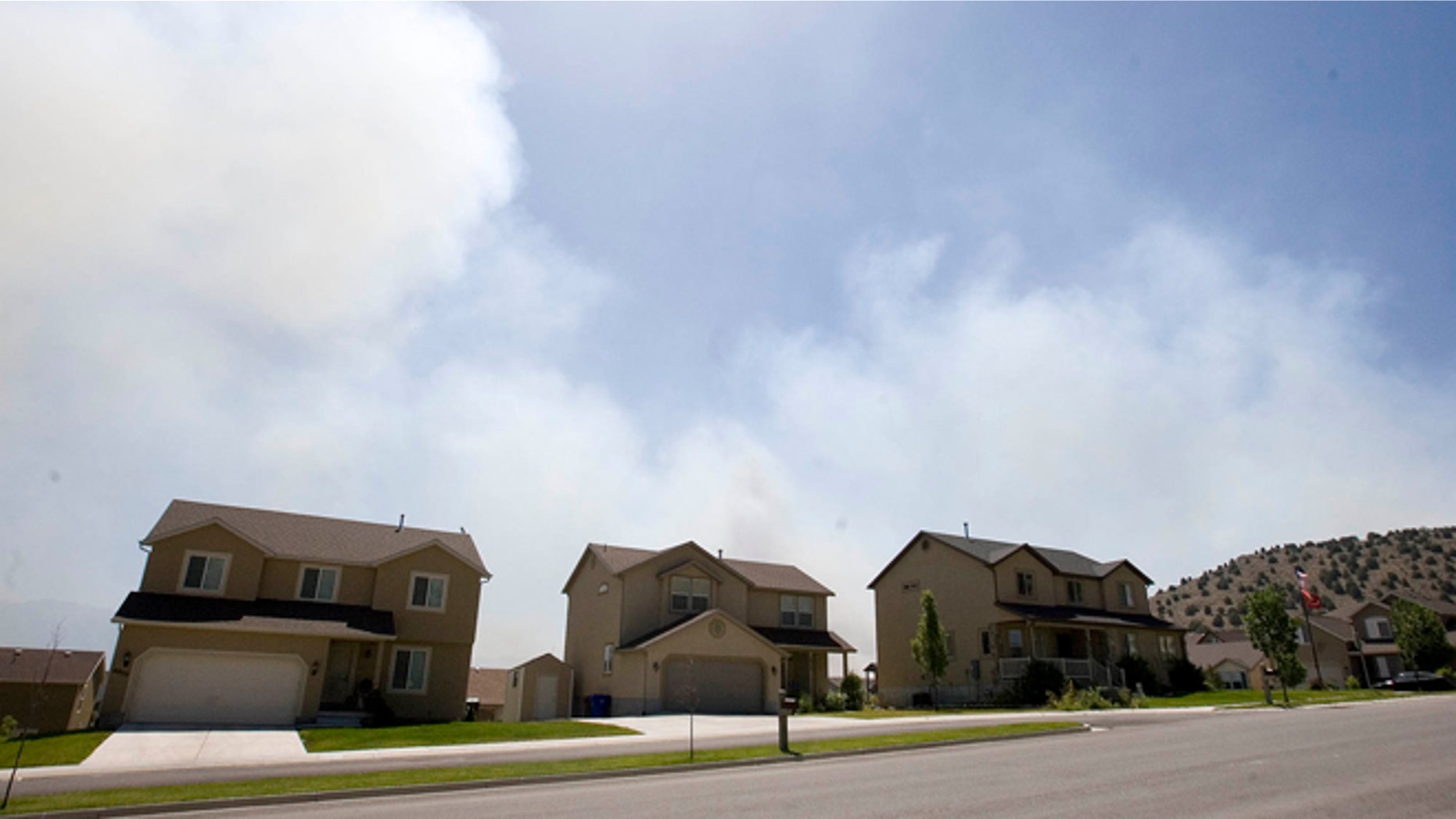 June 22, 2012: Smoke fills the sky as a fire burns near Eagle Mountain, Utah.