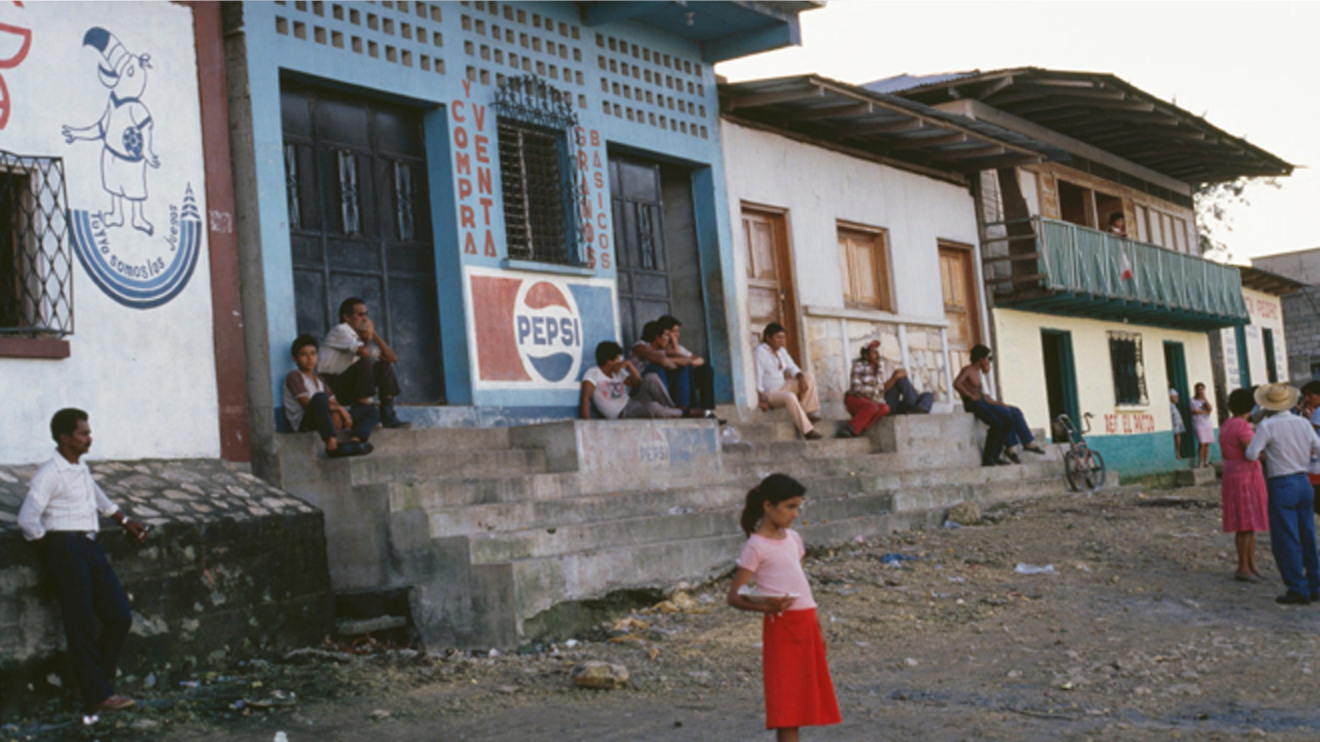 A young girl stands on the side of the road towards the El Ceibal Ruins, Guatemala City, November 1988 (Photo by Frances M. Ginter/Getty Images)