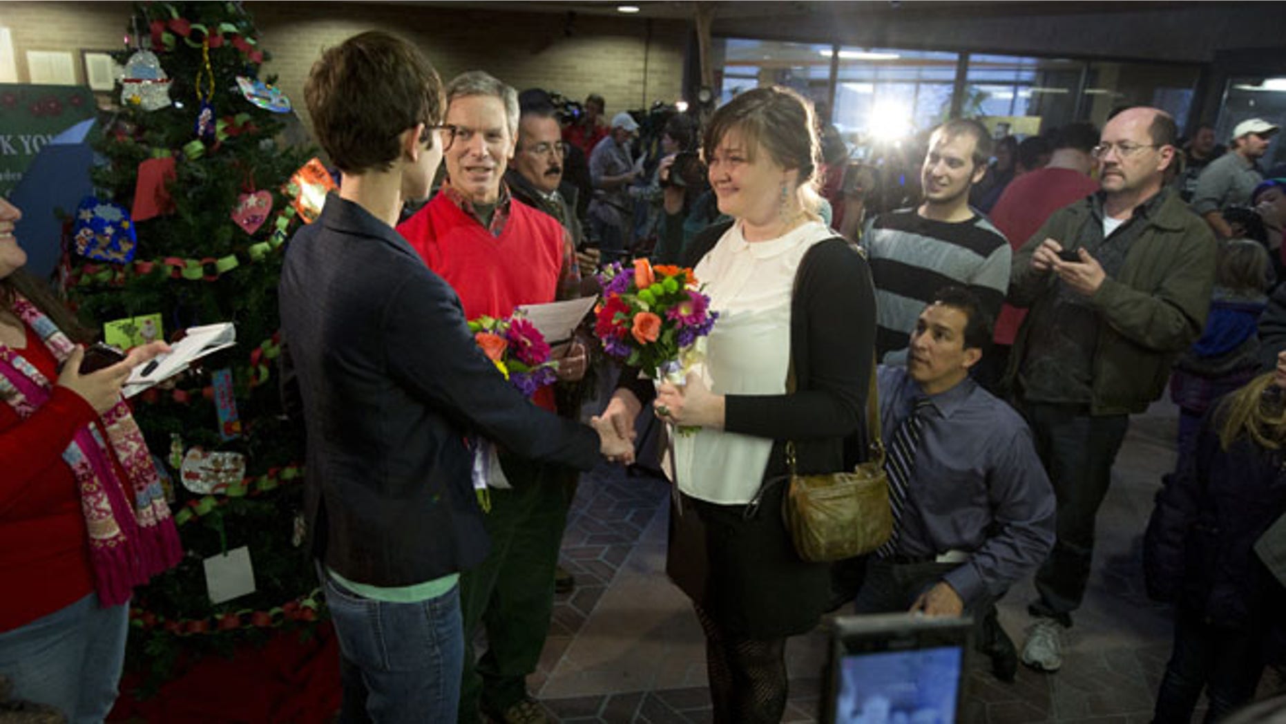 Dec. 20, 2013: Natalie Dicou, left, and Nicole Christensen, right, are married by Salt Lake City Mayor Ralph Becker, middle, in the lobby of the Salt Lake County Clerk's Office in Salt Lake City.