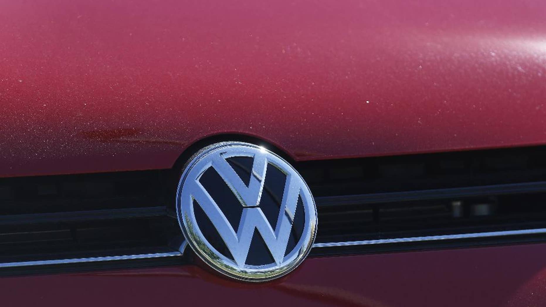 FILE - In this Sept. 24, 2015 file photo, the grille of a Volkswagen is decorated with the iconic company logo at on the lot of a VW dealership in Boulder, Colo. An expanding investigation into Volkswagen’s emissions-cheating scandal launched by state attorneys general could last years and will likely end in a negotiated settlement. (AP Photo/Brennan Linsley, File)