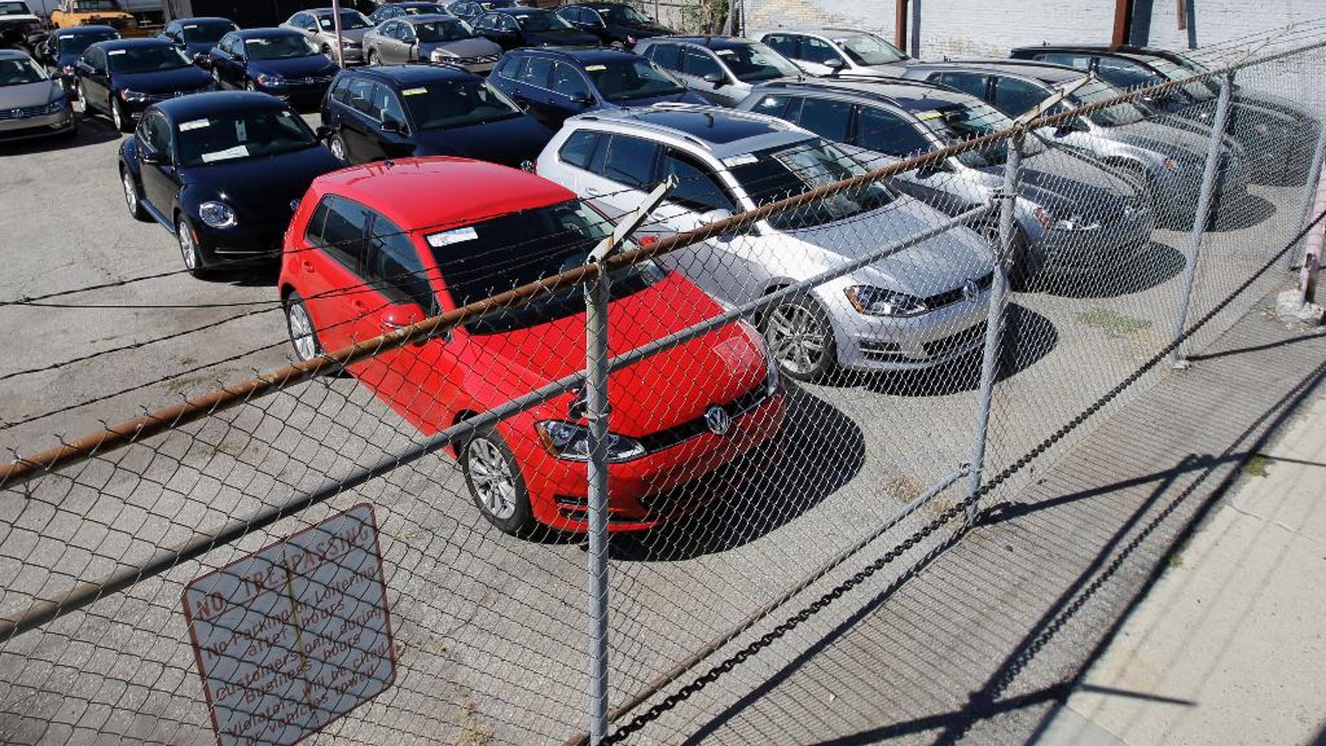 FILE - In this Sept. 23, 2015 file photo, diesel Volkswagens are seen behind a security fence on a storage lot near a VW dealership in Salt Lake City. Volkswagen is far from the first company to stand accused of trying to game required emissions tests. Almost since the passage of the Clean Air Act in 1970, major manufacturers of cars, trucks and heavy equipment have been busted for using what regulators call “defeat devices” _ typically programing a vehicle’s on-board computer to boost horsepower or fuel mileage by belching out dirtier exhaust than allowed. (AP Photo/Rick Bowmer, File)