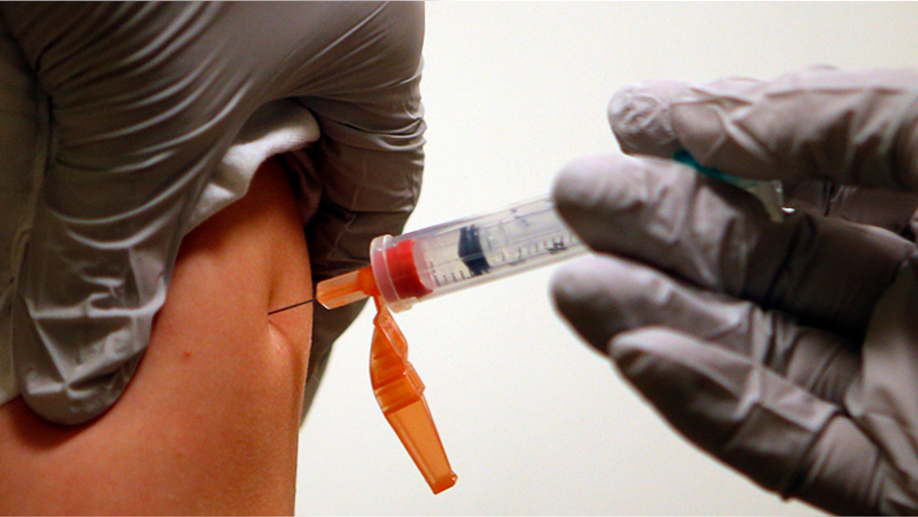 Six-year-old Diego Sanson receives an influenza vaccine injection at Massachusetts General Hospital in Boston, Massachusetts January 10, 2013. With flu cases in this city up tenfold from last year, the mayor of Boston declared a public health emergency January 9 as authorities around the United States scrambled to cope with a rising number of patients. REUTERS/Brian Snyder (UNITED STATES - Tags: HEALTH SOCIETY) - RTR3CANZ