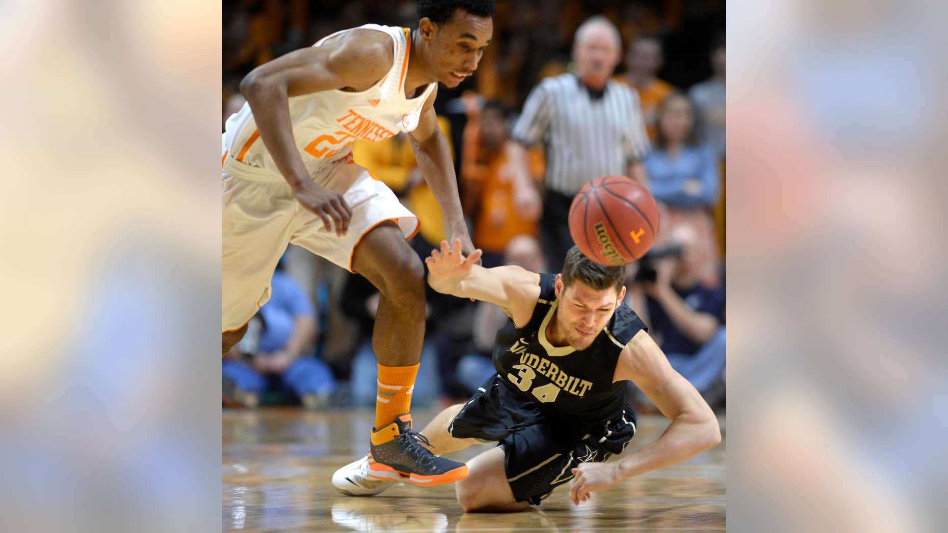 Tennessee guard Derek Reese (23) makes a steal from Vanderbilt forward Shelby Moats (34) during the first half of an NCAA college basketball game at the Thompson-Boling Arena in Knoxville, Tenn. on Saturday, March 1, 2014. (AP Photo/Knoxville News Sentinel, Adam Lau)