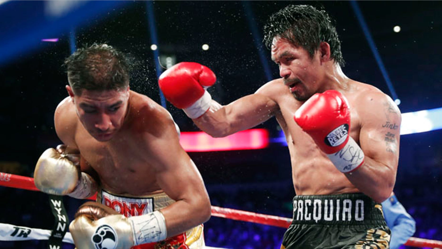 Jessie Vargas, left, tries to avoid a punch from Manny Pacquiao, of the Philippines, during their WBO welterweight title boxing match, Saturday, Nov. 5, 2016, in Las Vegas. (AP Photo/Isaac Brekken)