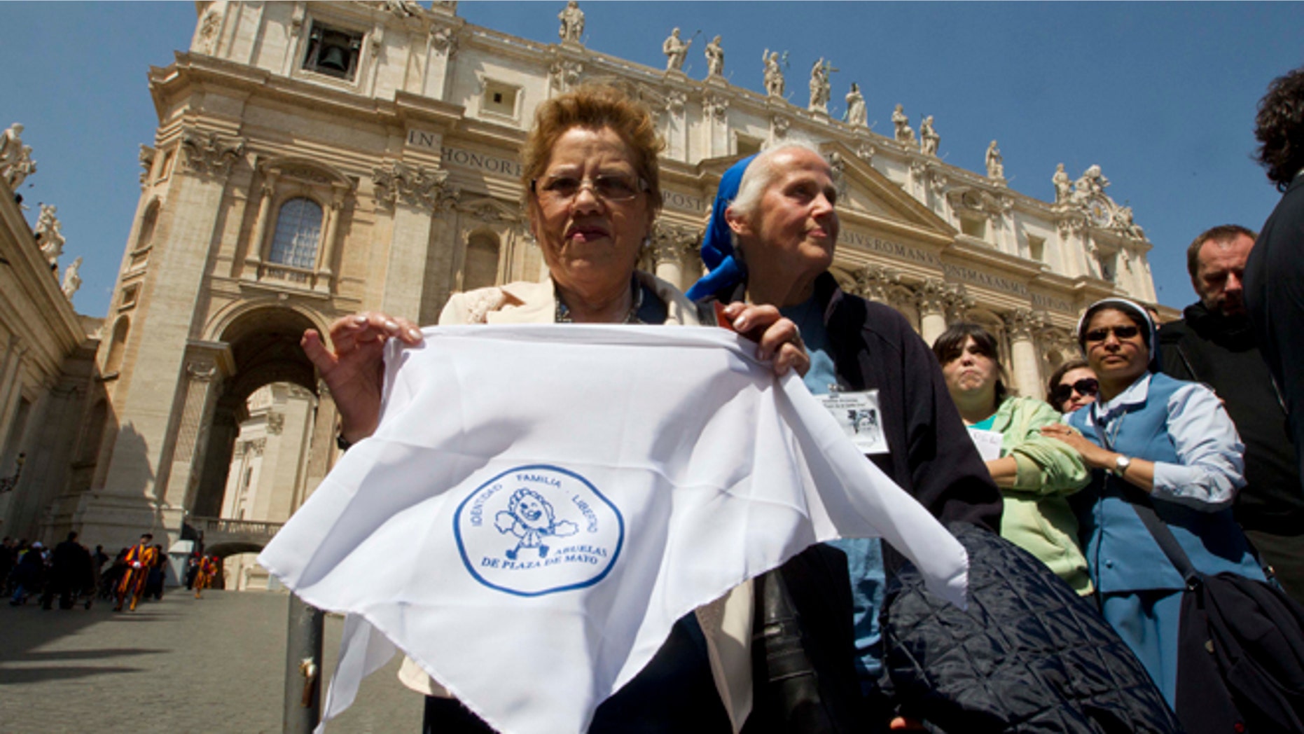 Grandmothers of the Plaza de Mayo activist Buscarita Roa, of Chile, shows a scarf with the symbol of the Grandmothers of the Plaza de Mayo association, in St. Peter's Square after meeting Pope Francis at the end of his weekly general audience at the Vatican. (AP Photo/Alessandra Tarantino)