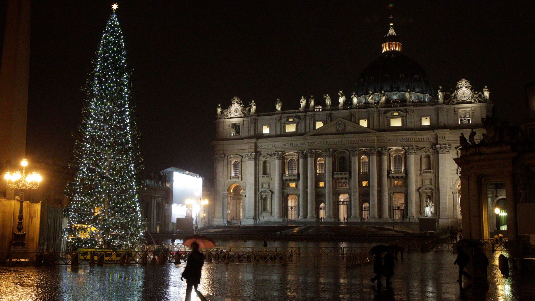 Dec. 17: People walk past the Christmas tree in St. Peter's square, at the Vatican, that was lit for the first time Dec. 17.