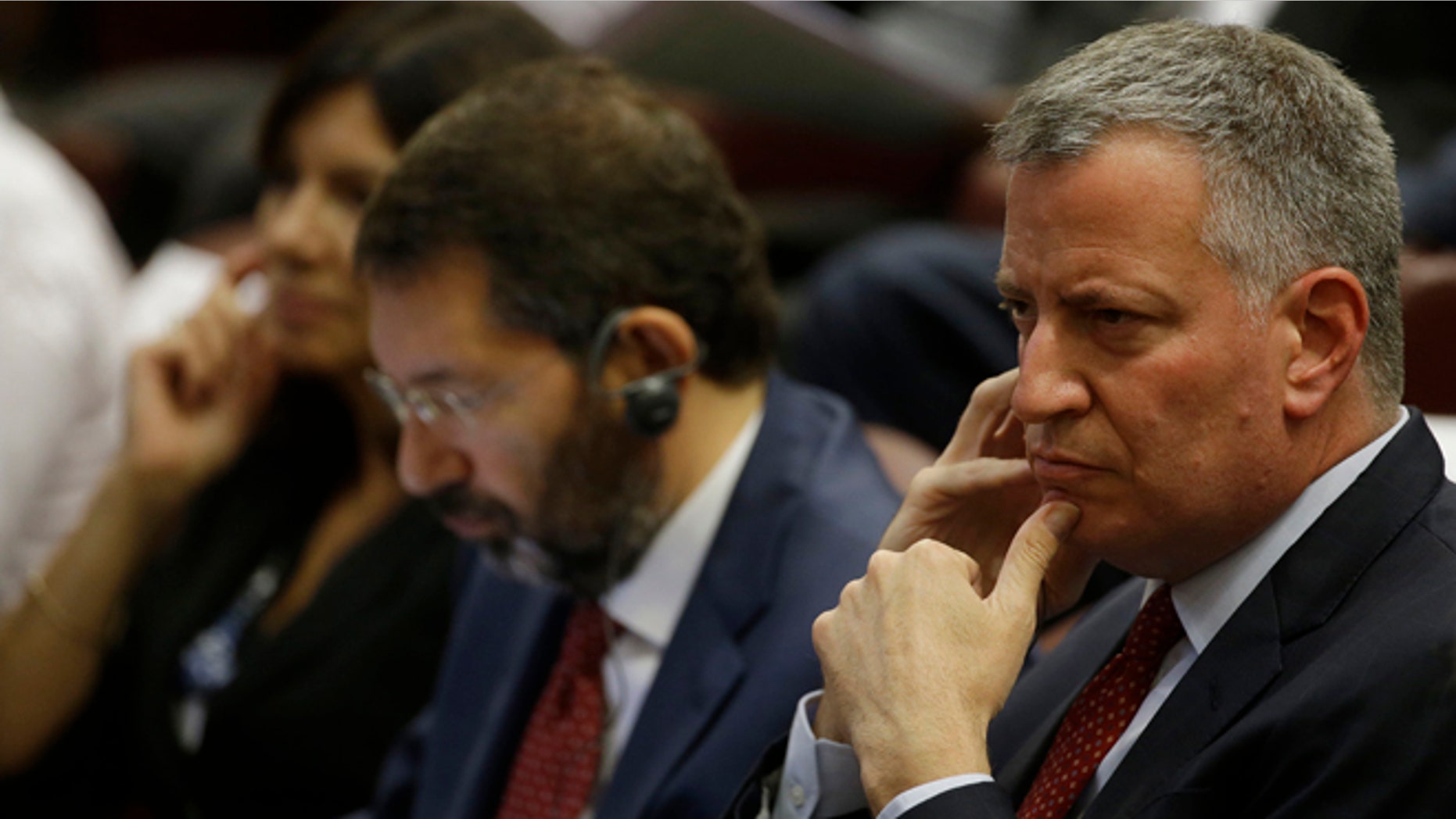 New York Mayor Bill de Blasio, right, flanked by Rome Mayor Ignazio Marino, center, and Paris Mayor Anne Hidalgo attend a conference on Modern Slavery and Climate Change in the Synod Hall at the Vatican, Tuesday, July 21, 2015. Dozens of environmentally friendly mayors from around the world are meeting at the Vatican this week to bask in the star power of eco-Pope Francis and commit to reducing global warming and helping the urban poor deal with its effects. (AP Photo/Gregorio Borgia)