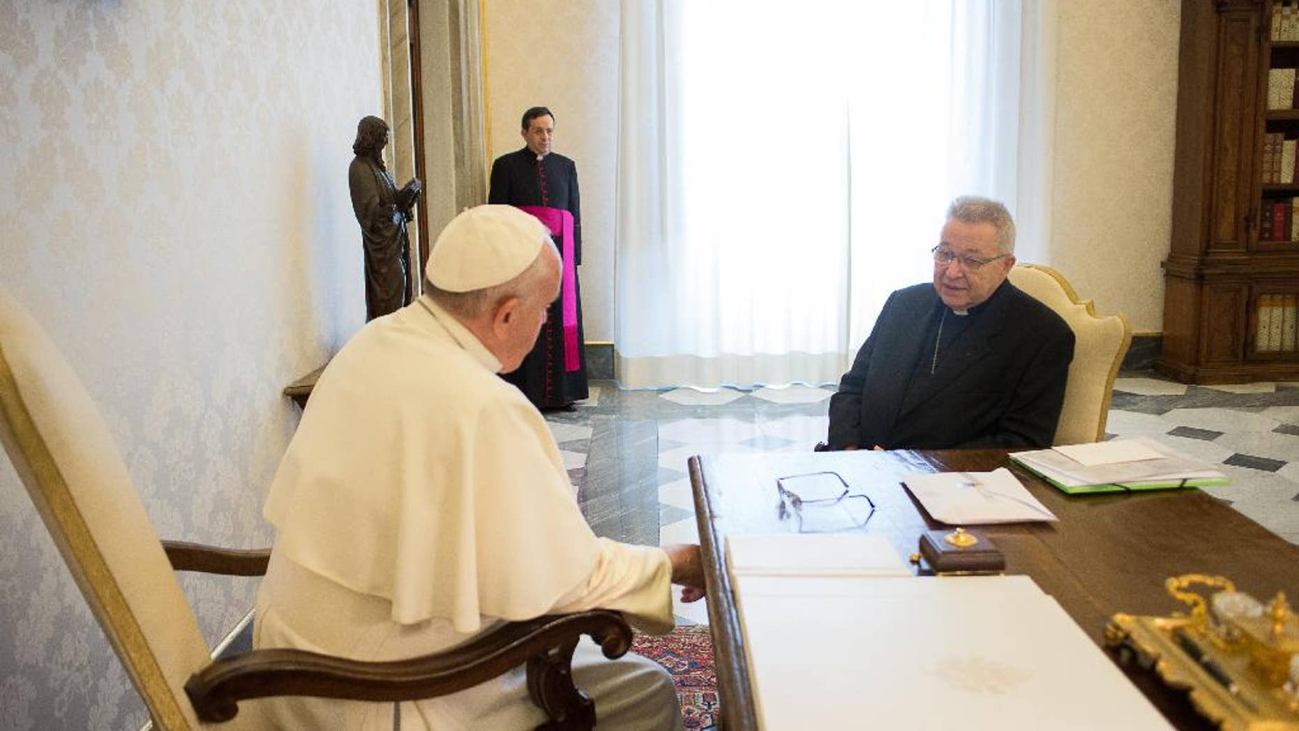 Pope Francis meets Archbishop of Paris, Cardinal André Vingt-Trois, during a private audience at the Vatican, Thursday, Jan. 8, 2015. Pope Francis has celebrated a Mass in memory of the victims of the Charlie Hebdo massacre, decrying the "human cruelty" that people are capable of. Francis asked for prayers for the victims at the start of Mass and said "we also ask for those who are cruel so that the Lord may change their heart." (AP Photo/L'Osservatore Romano, Pool)