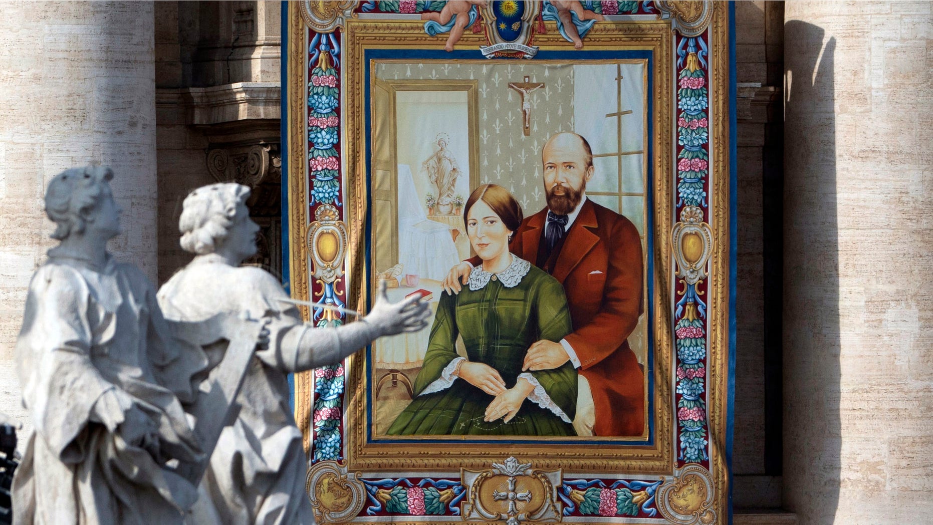 A tapestry showing Louis and Zelie Martin, parents of St. Therese of Lisieux, hangs from a balcony of St. Peter's Basilica at the Vatican, Sunday, Oct. 18, 2015. Pope Francis canonized the Catholic Church's first married couple in modern times on Sunday, declaring the parents of the beloved St. Therese of Lisieux saints in their own right. (AP Photo/Alessandra Tarantino)