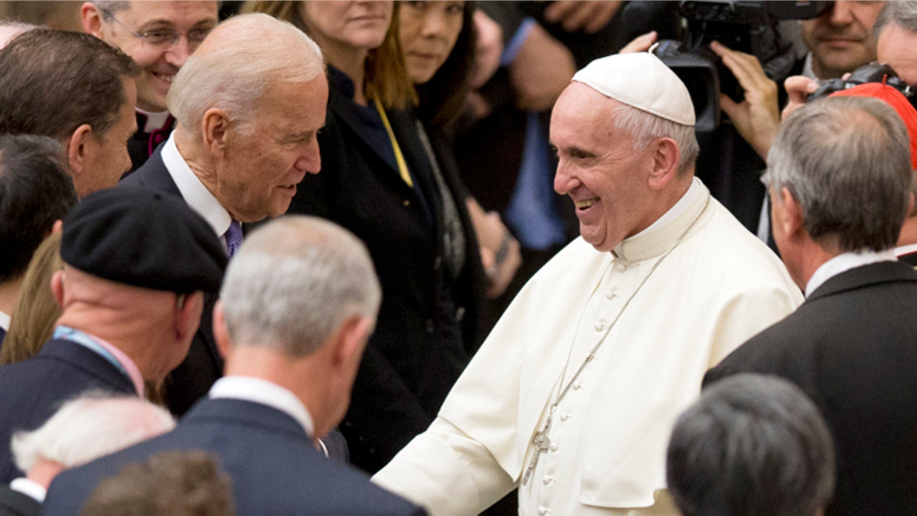 Pope Francis shakes hands with US vice president Joe Biden as he takes part at a congress on the progress of regenerative medicine and its cultural impact, being held in the Pope Paul VI hall at the Vatican, Friday, April 29, 2016. (AP Photo/Andrew Medichini)