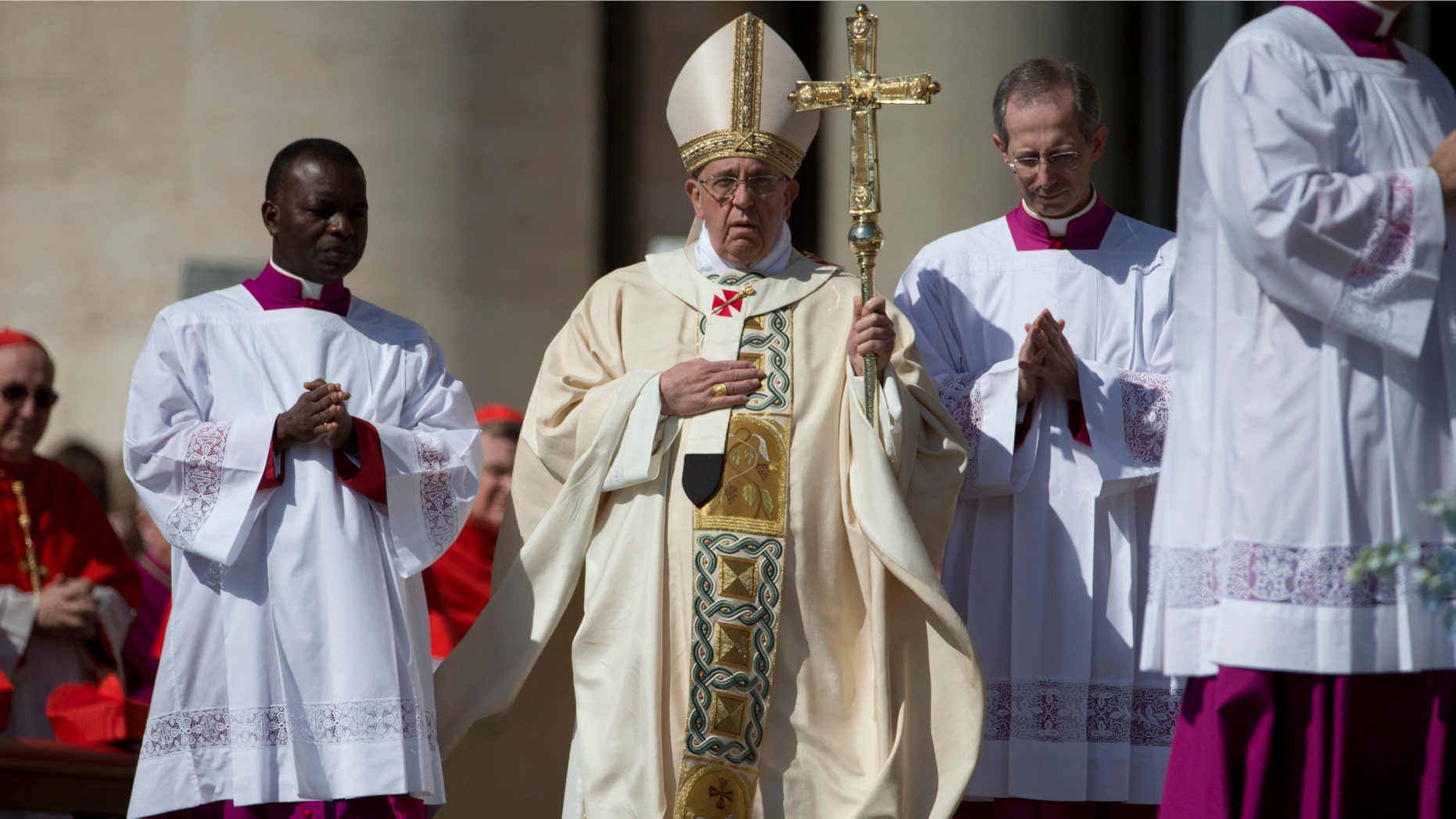 Pope Francis, center, arrives to celebrate an Easter Sunday Mass in St. Peter's Square at the Vatican Sunday, April 20, 2014. (AP Photo/Andrew Medichini)