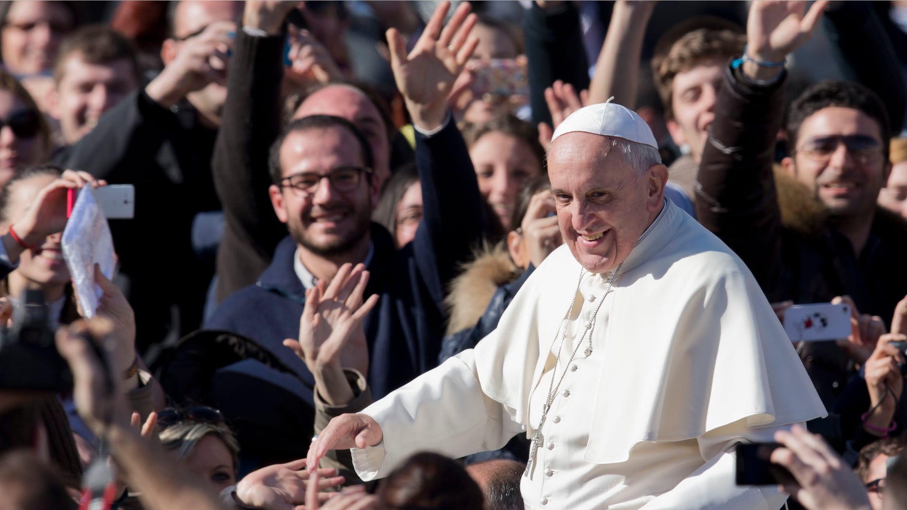 Pope Francis greets faithful as he leaves St. Peter's Square at the Vatican, Friday, Feb. 14, 2014. Pope Francis met a group of engaged couples on Valentine's Day. (AP)