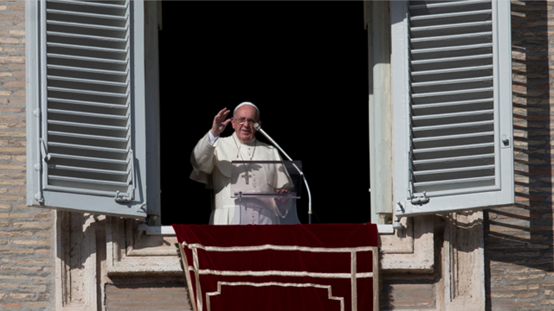 November 16, 2014: Pope Francis delivers his blessing during the Angelus noon prayer from his studio's window overlooking St. Peter's Square. (AP)