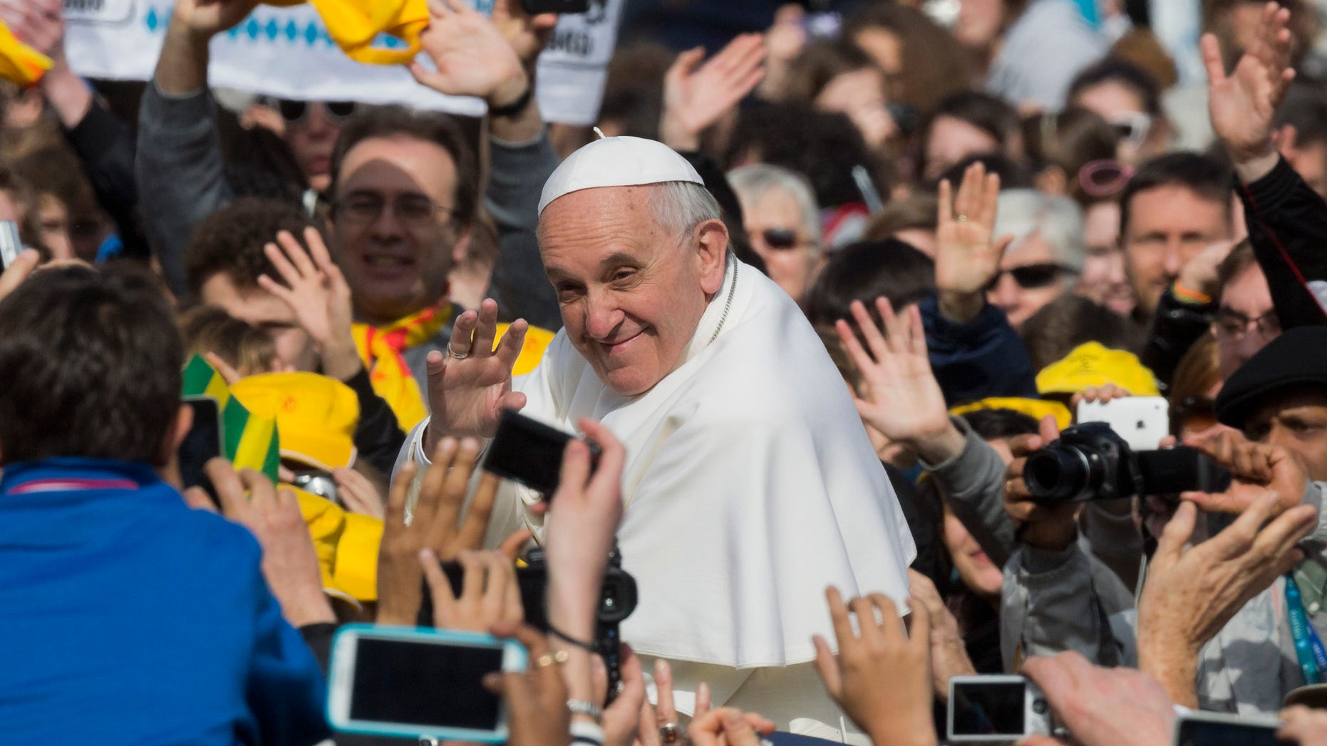 Pope Francis waves as he tours St. Peter's Square at the Vatican in his popemobile prior to his weekly general audience, Wednesday, April 3, 2013. (AP Photo/Domenico Stinellis)