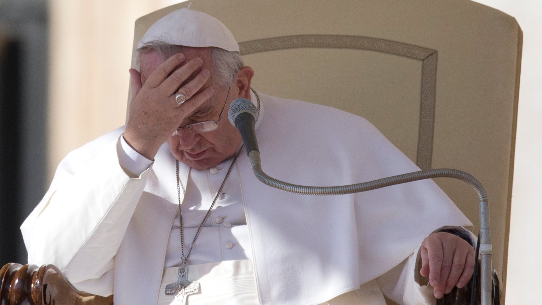 Pope Francis touches his forehead during his weekly general audience, in St. Peter's Square, at the Vatican, Wednesday, Feb. 18, 2015. (AP Photo/Andrew Medichini)