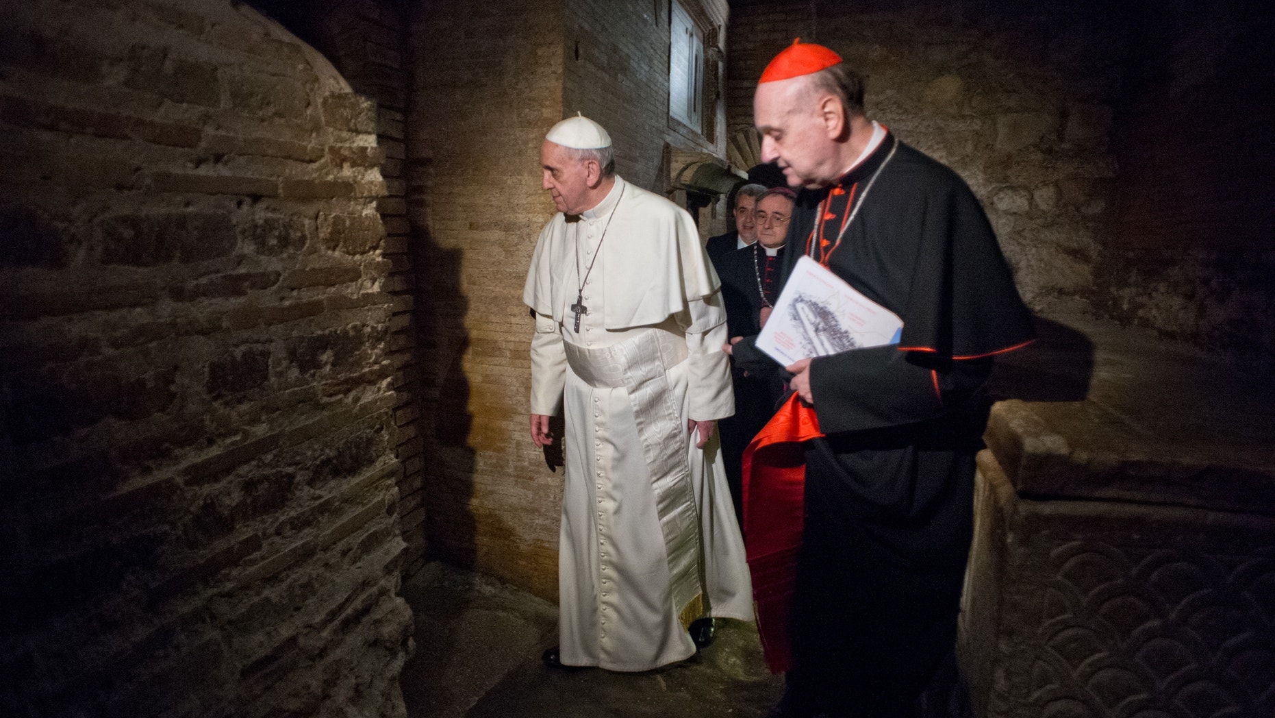 April 1, 2013 - Pope Francis, followed by Cardinal Angelo Comastri, right, and Bishop Vittorio Lanzani, partially hidden, visits the necropolis where pagans and early Christians were buried under St. Peter’s Basilica at the Vatican and where St. Peter is believed to be buried.