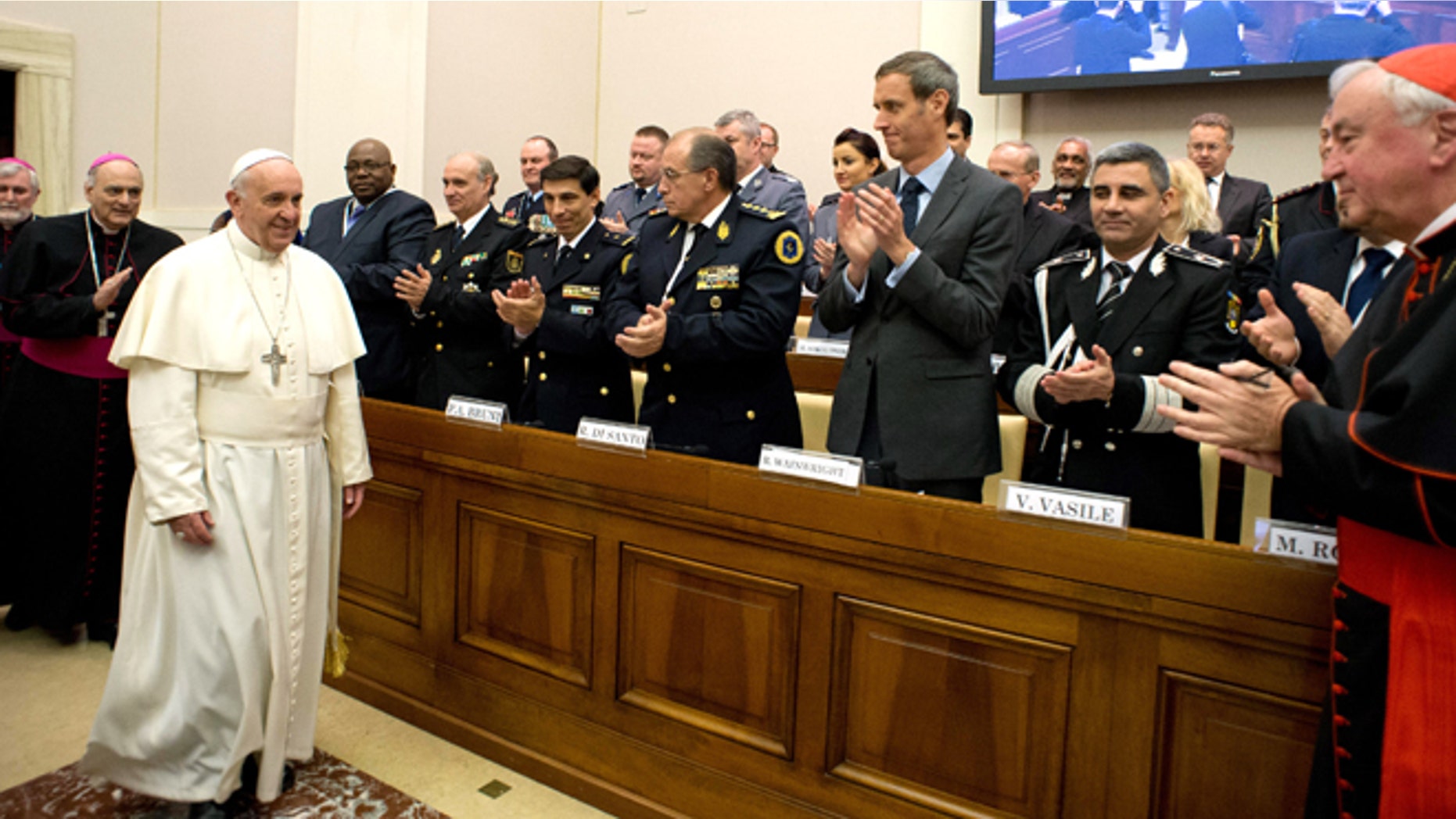 April 10, 2014: In this photo released by Vatican newspaper L'Osservatore Romano Pope Francis arrives at a conference about the human trafficking, at the Vatican.