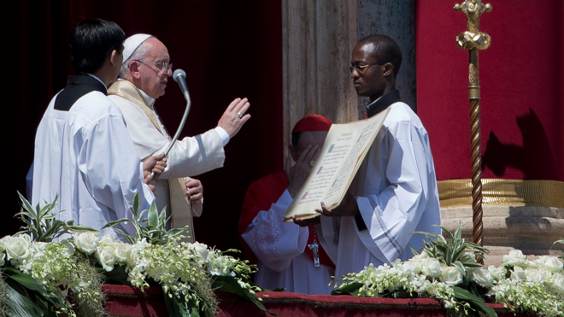 April 20, 2014: Pope Francis delivers his blessing at the end of the Urbi and Orbi (Latin for to the city and to the world) blessing from the balcony of St. Peter's Basilica at the end of the Easter Mass in St. Peter's Square at the the Vatican.